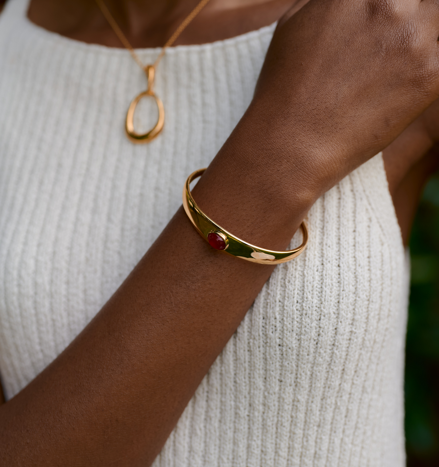Dhruva Cuff gold bracelet with red onyx stone on wrist