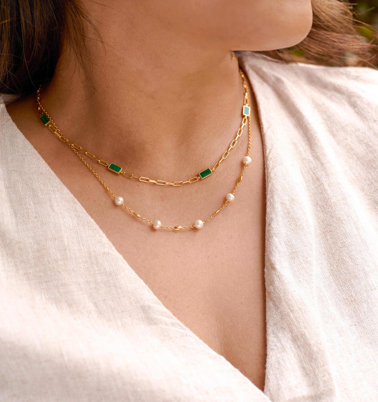 Close-up of Manjari Necklace with five pearls and gold chain worn on neck