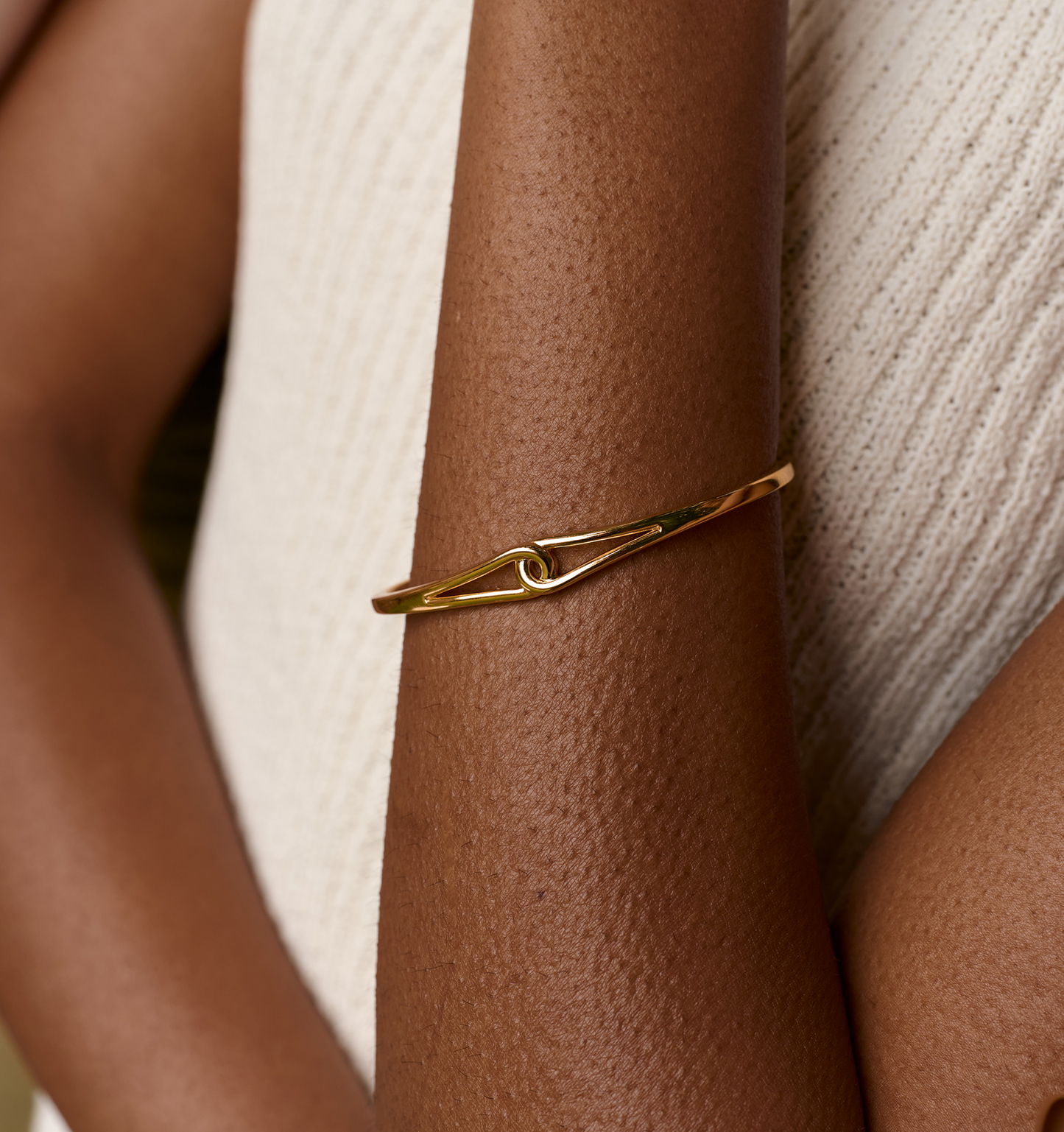 Minimalist gold Vetra Cuff bracelet with a unique twisted design on wrist