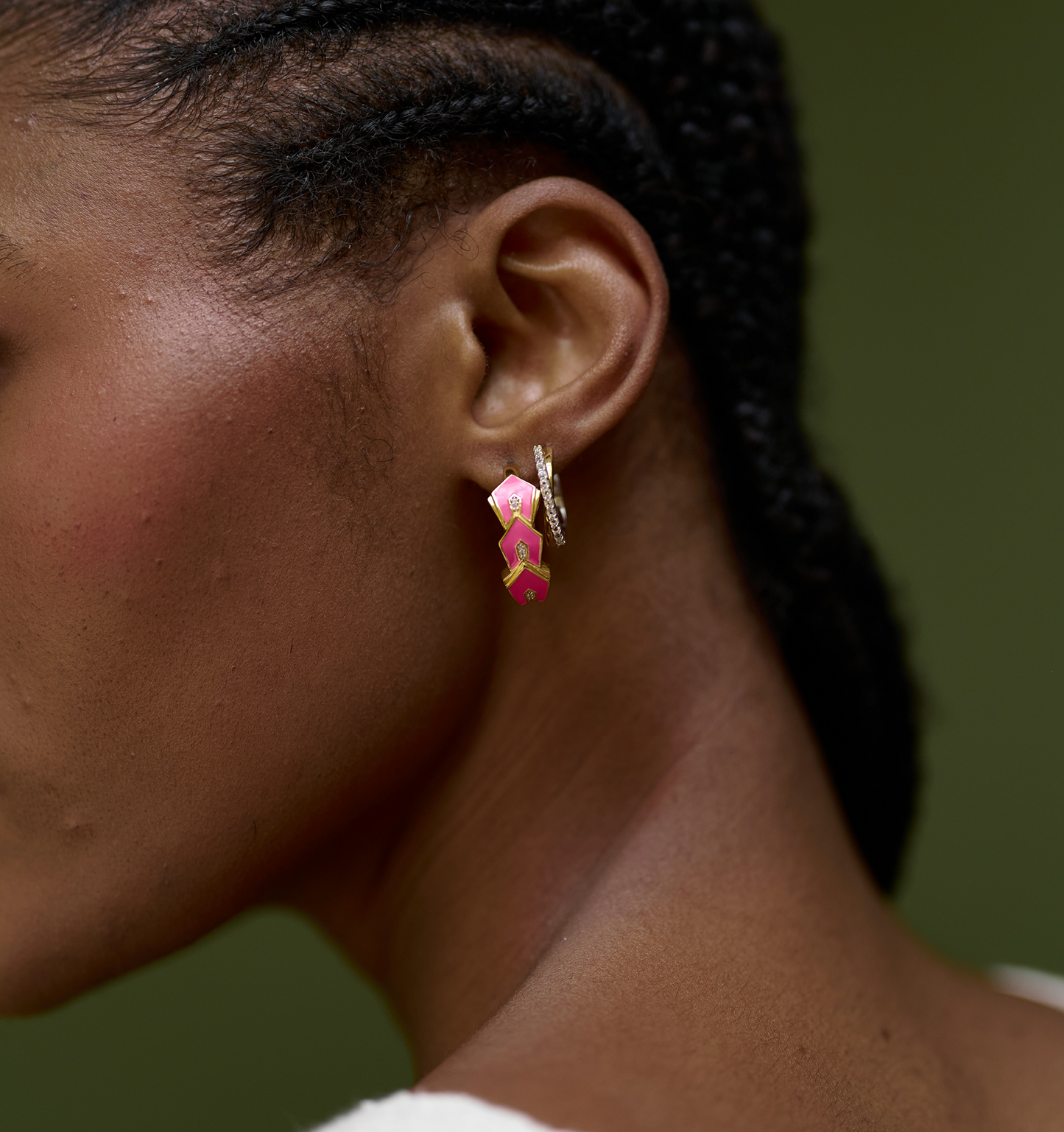Close-up of ear wearing Gulzar Petal Dew pink enamel and gold-plated hoop earrings with white topaz accents