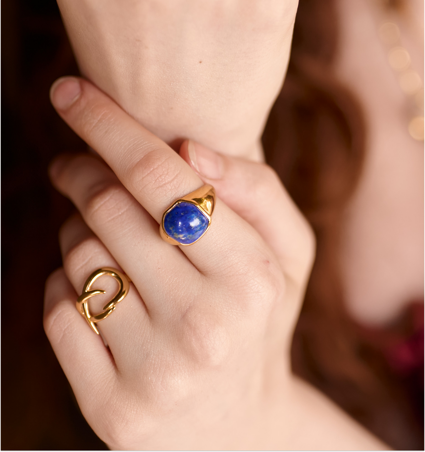 Karvat Ring gold with blue stone worn on hand showcasing elegant curved design