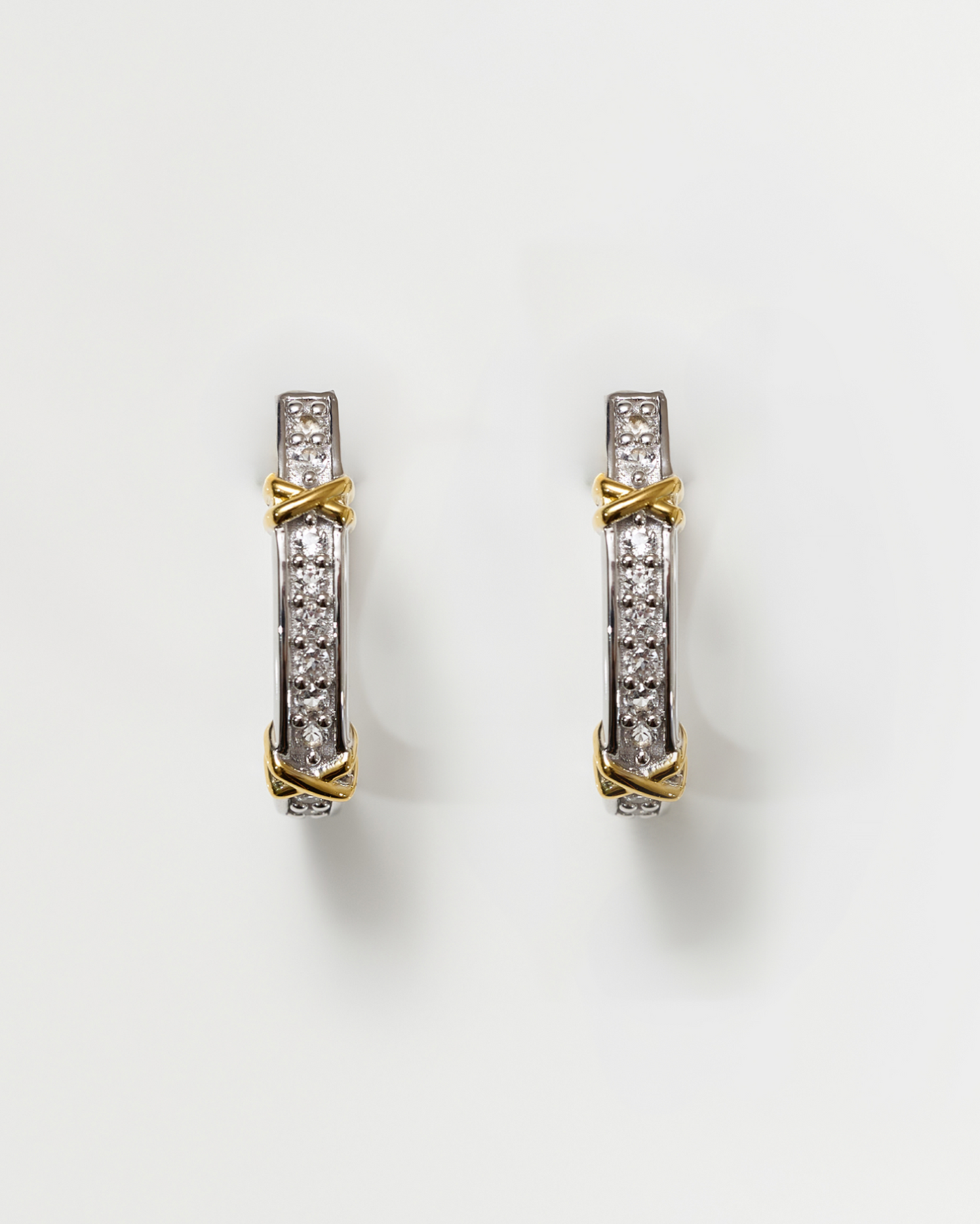 Aarvi Hoops gold and silver earrings with pavé white topaz gemstones in a sleek curved design