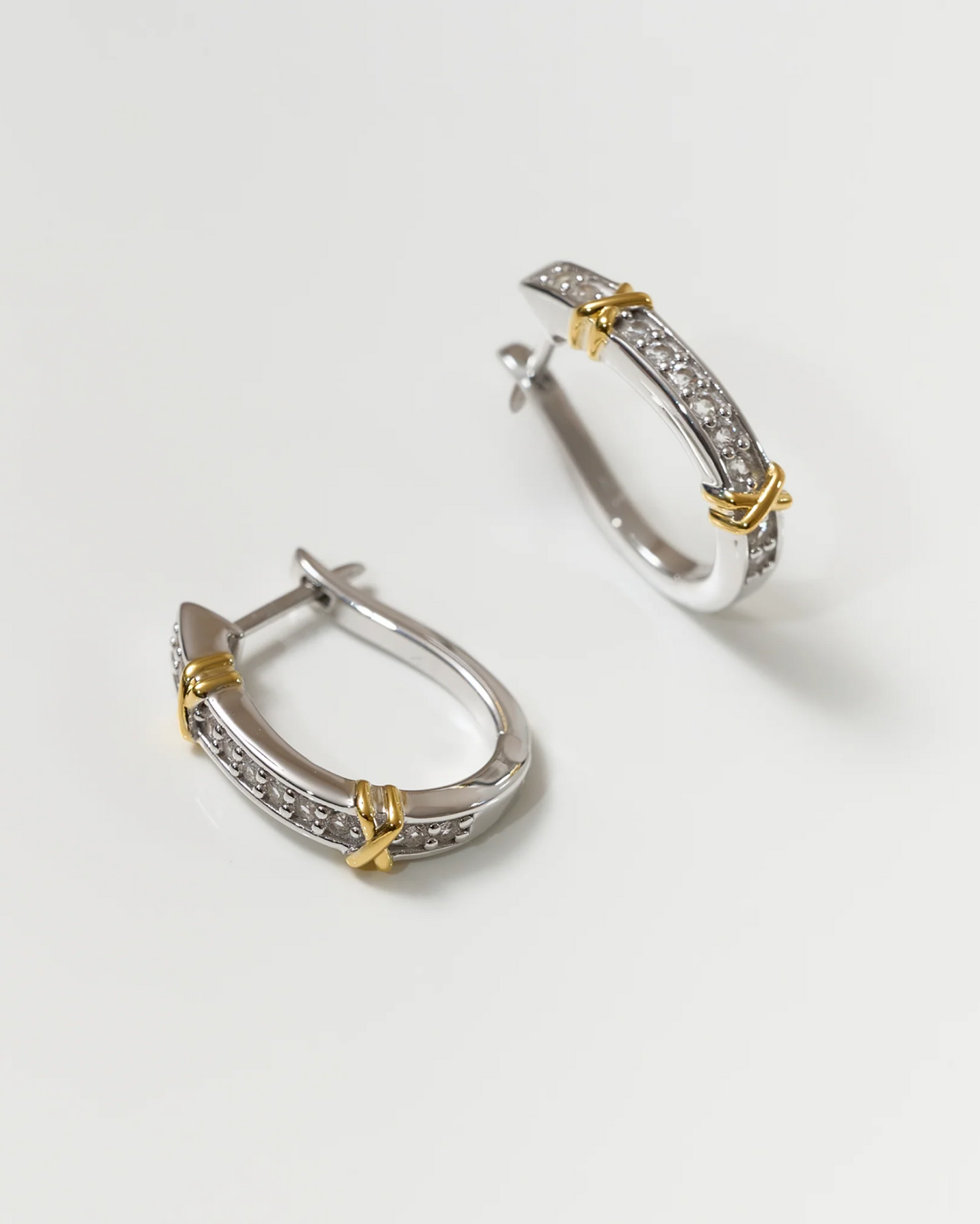 Aarvi Hoops gold and silver earrings with pavé white topaz stones and unique curve design