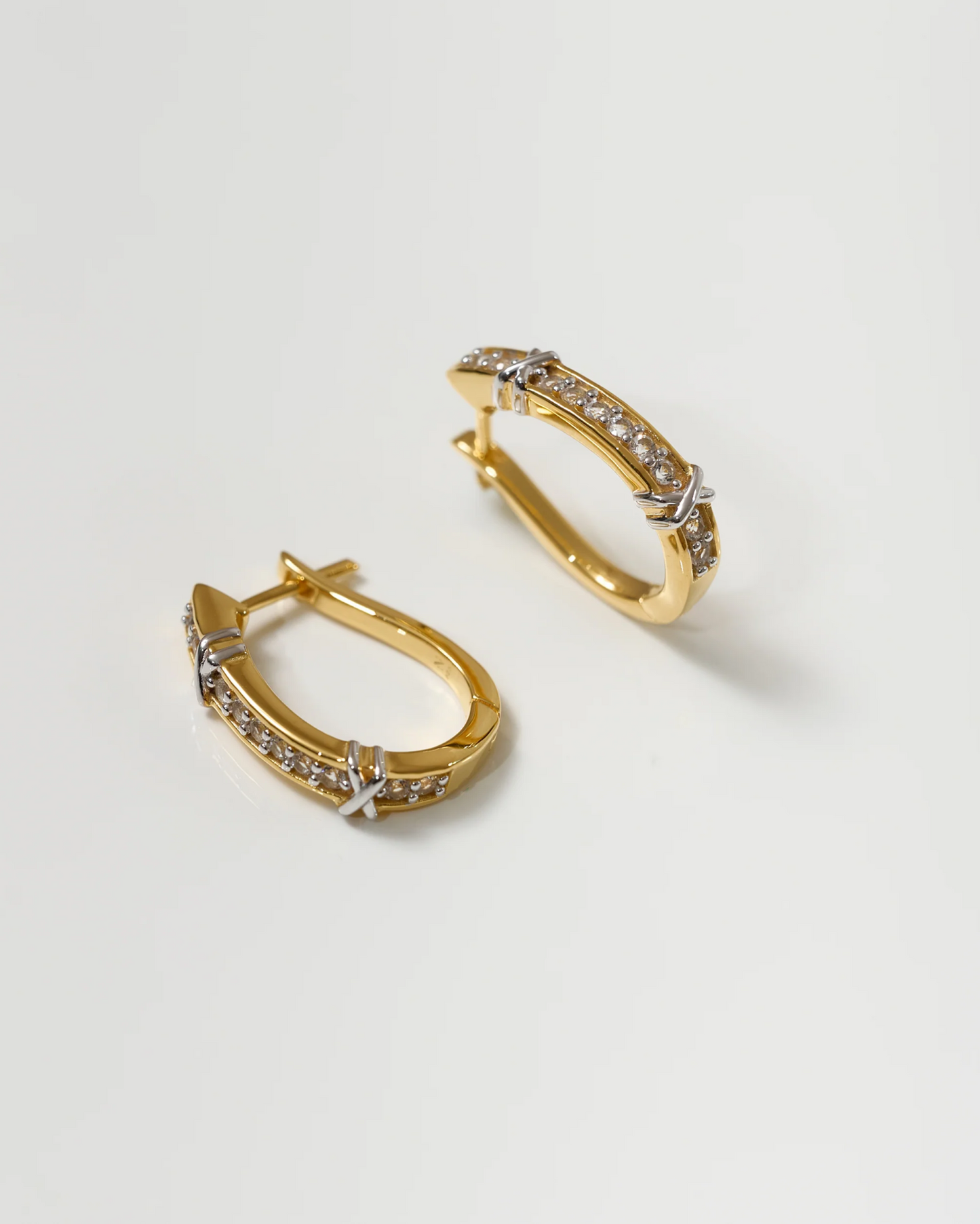 Aarvi Hoops gold earrings with pavé white topaz stones on a white background