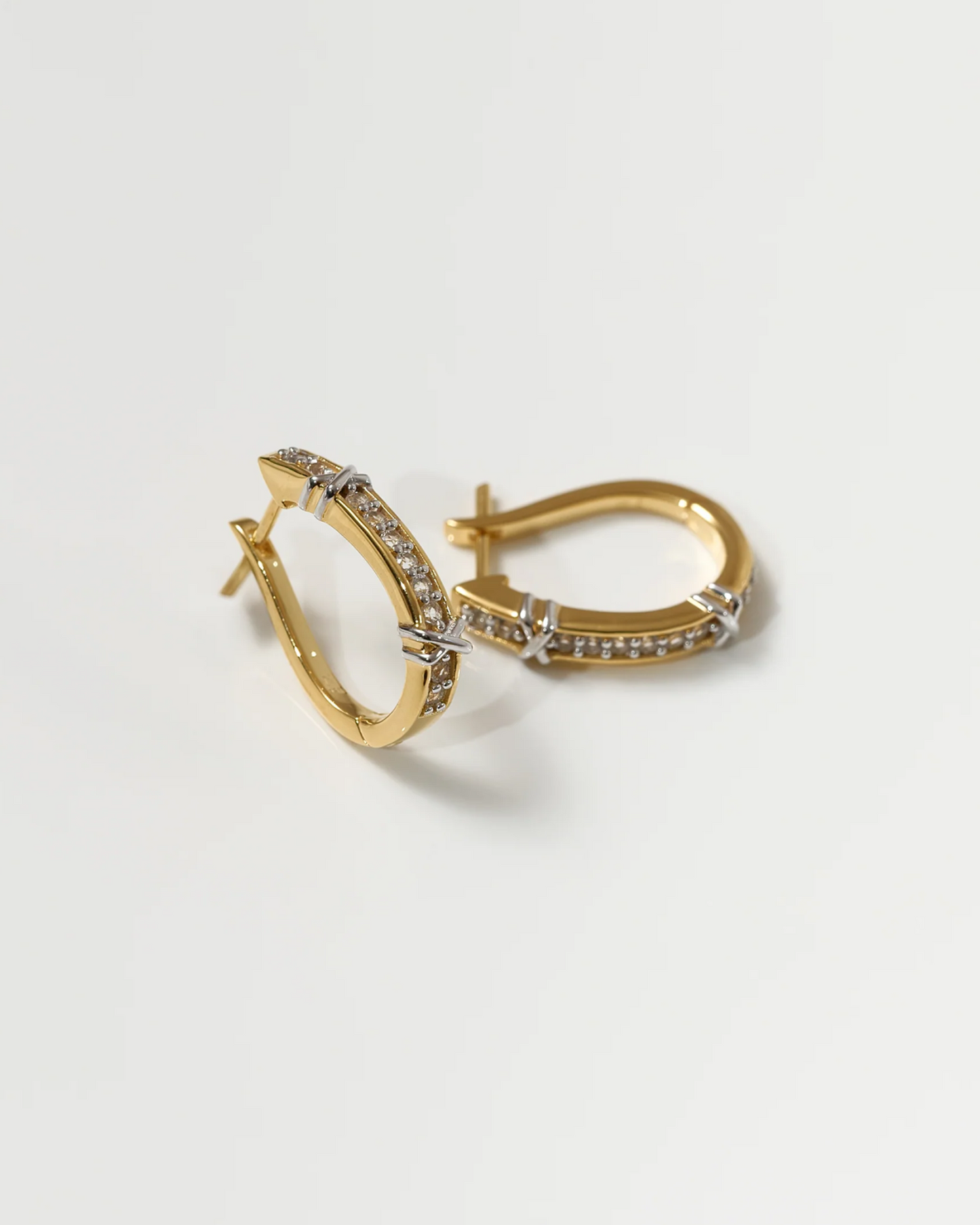 Aarvi Hoops gold earrings with pavé white topaz stones in a curved design