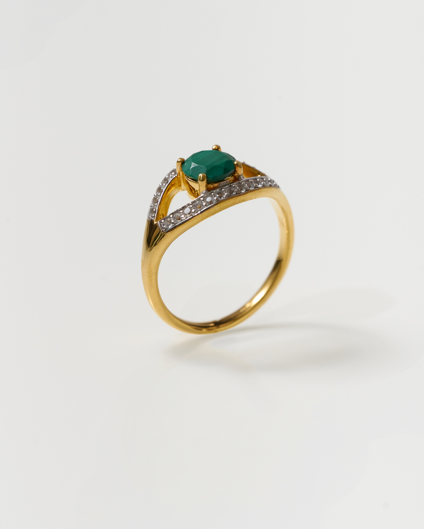 Saena Ring gold band with green stone and diamond accents isolated on white background