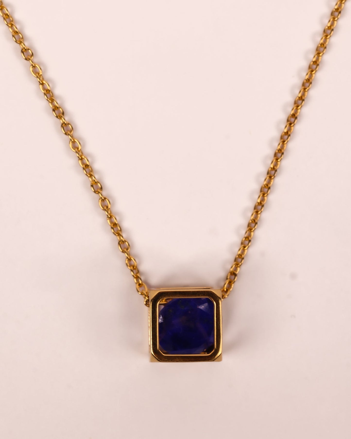 Kosha Necklace with round lapis lazuli stone in a gold square frame, modern and elegant design