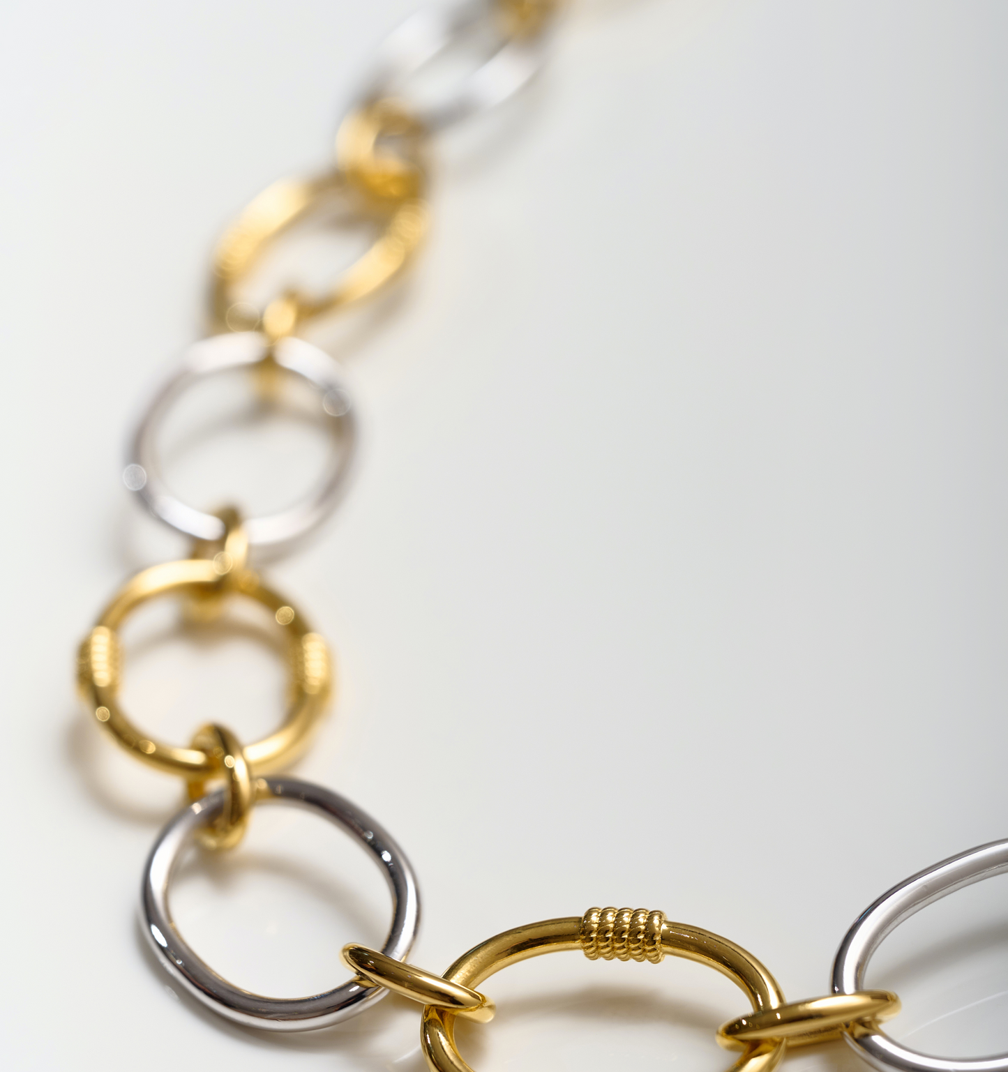 Tasya Necklace featuring interlinked gold and silver rings in a modern, balanced design