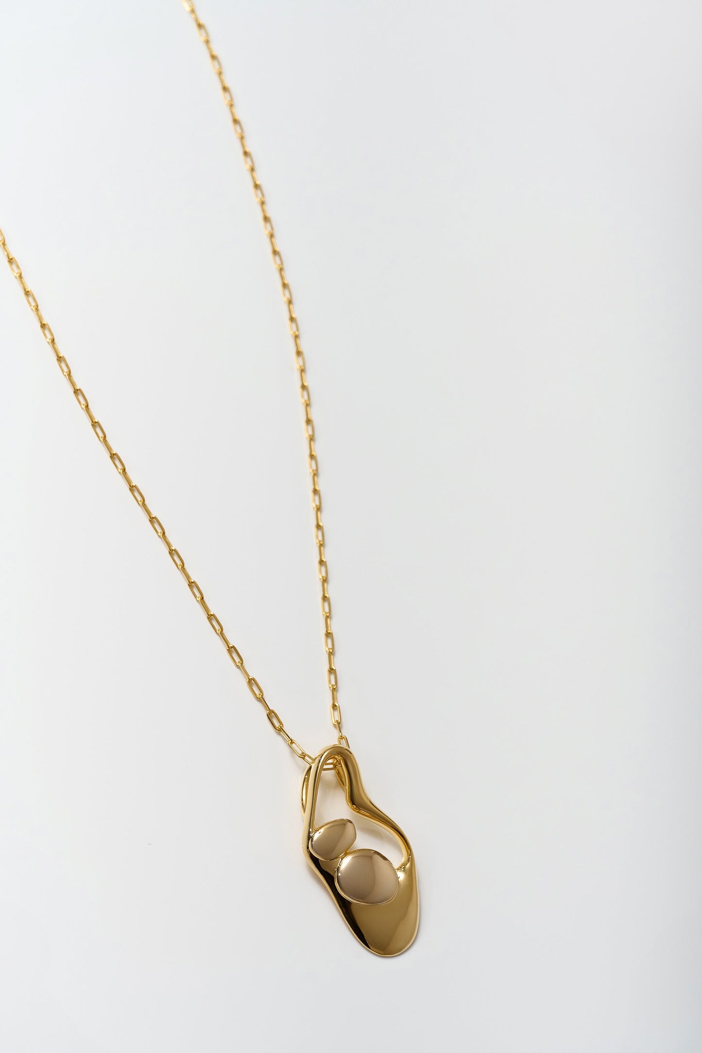Aakar Necklace fluid gold abstract pendant on delicate gold chain minimal design