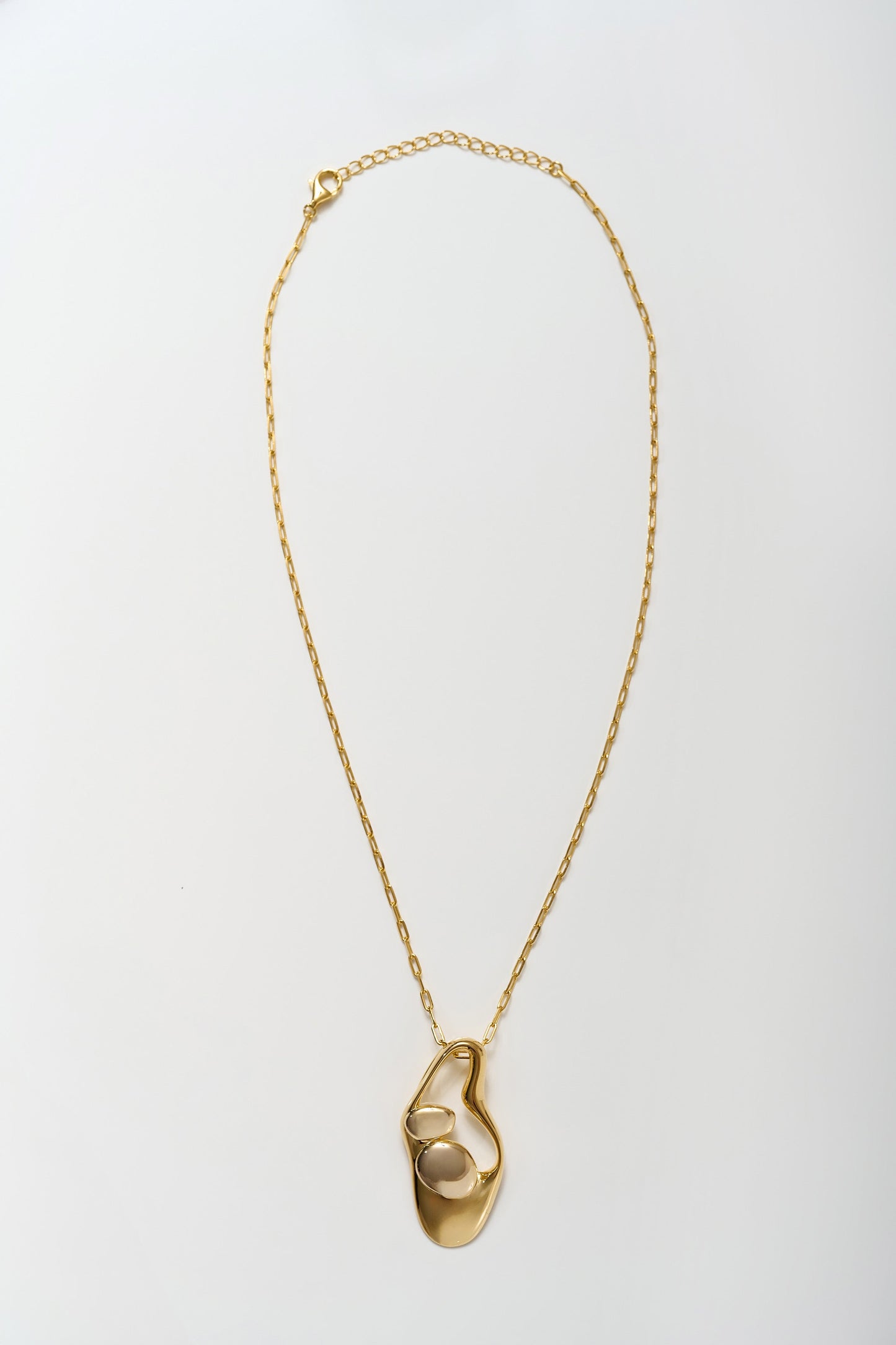 Minimalist Aakar Necklace in fluid gold with abstract sculpted pendant design