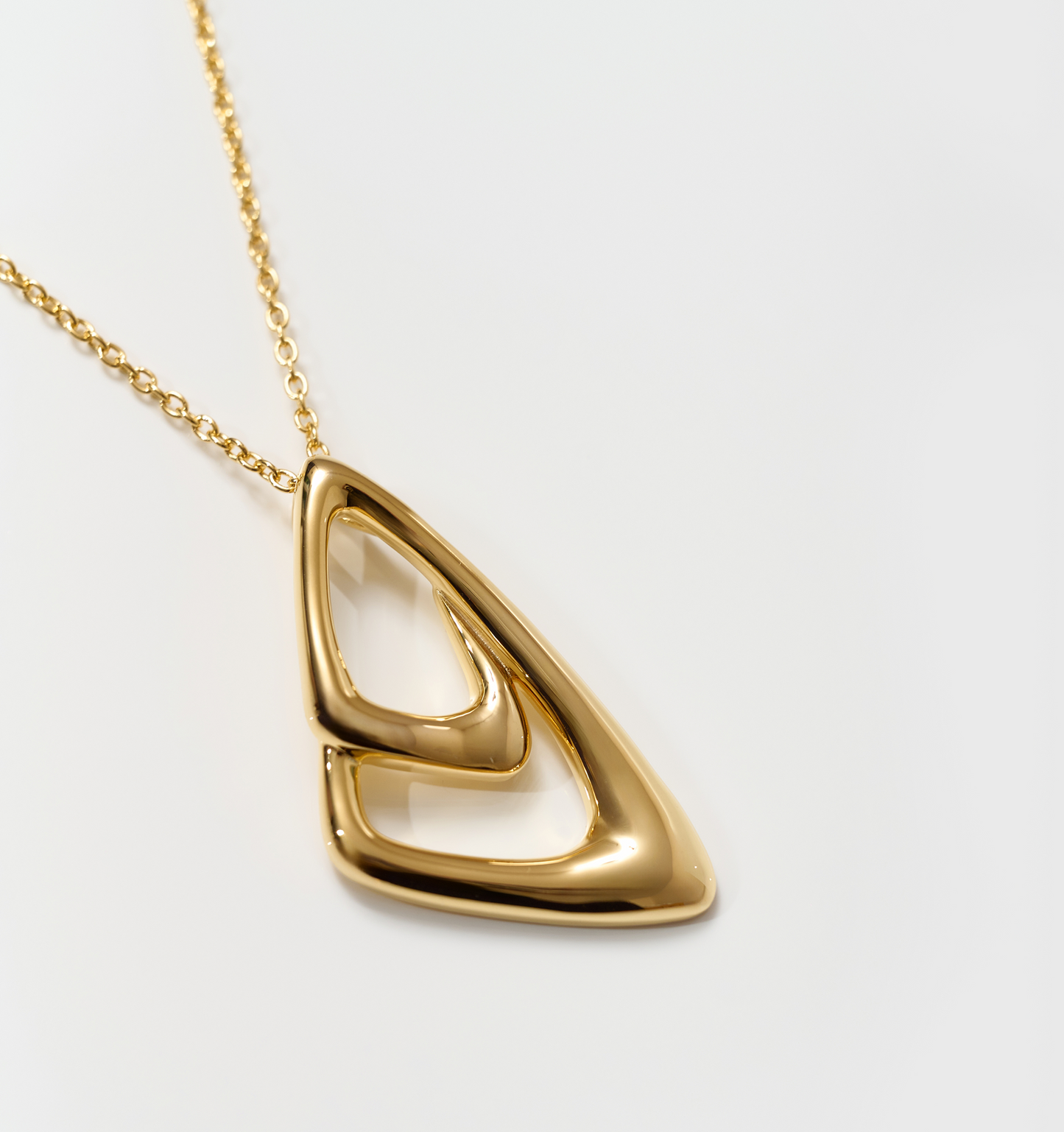Aavrit Necklace gold pendant with elegant triangular curves on chain
