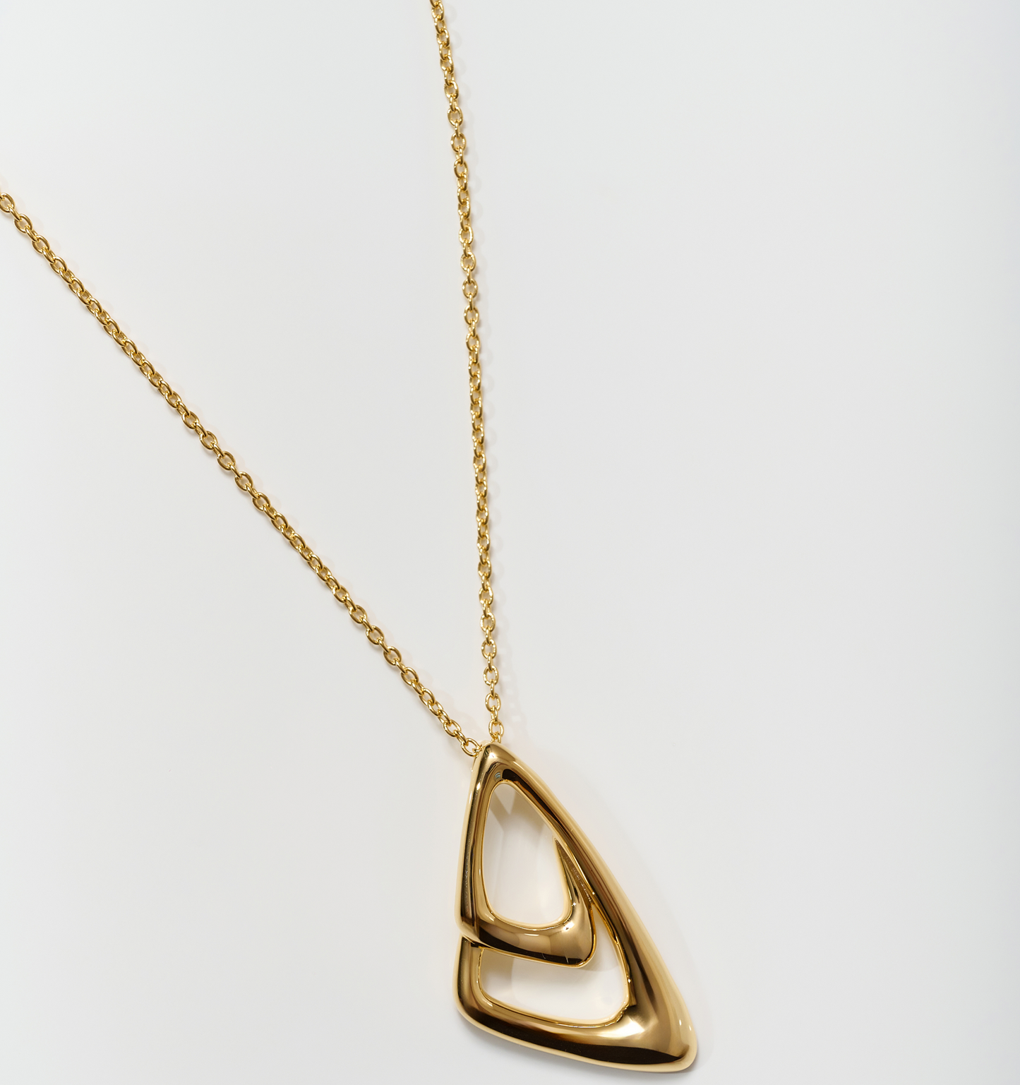 Aavrit Necklace gold pendant with elegant curved design on delicate chain
