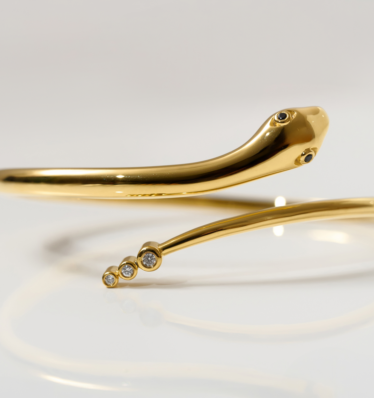 Gold Sarpa Cuff serpent bracelet with black spinel eyes and diamond-tipped tail.