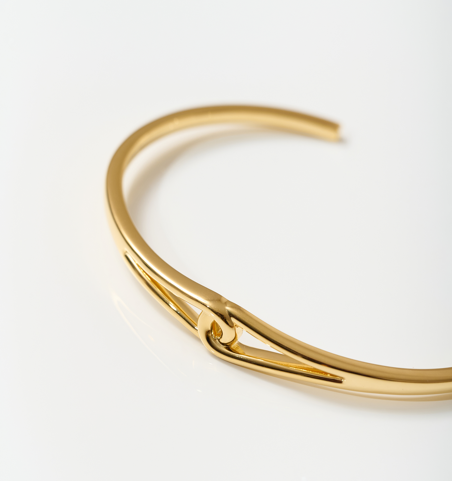Vetra Cuff minimalist gold bracelet with clean lines and focal knot design