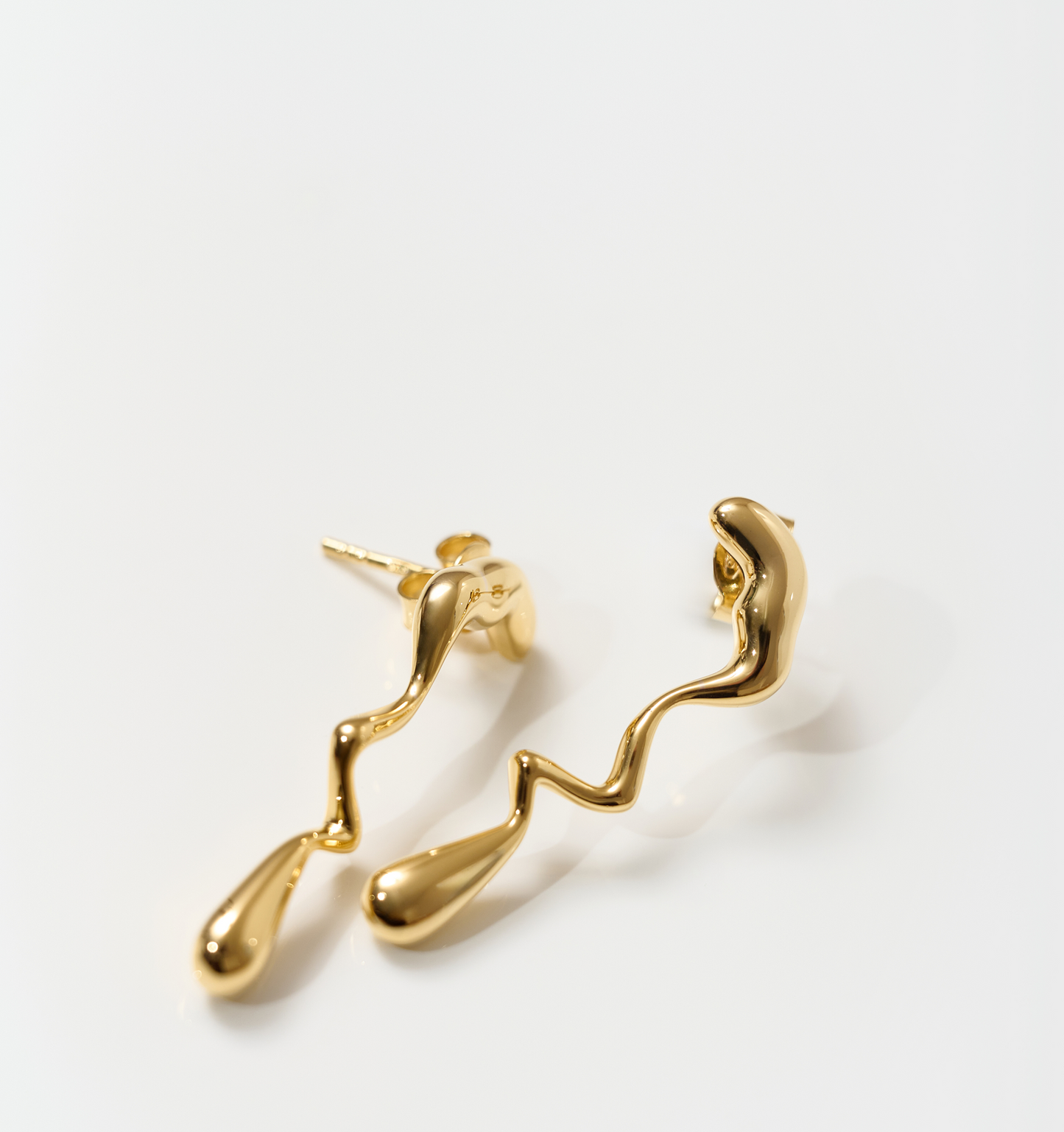 Gold Caia Earrings with fluid flame-inspired sculptural design