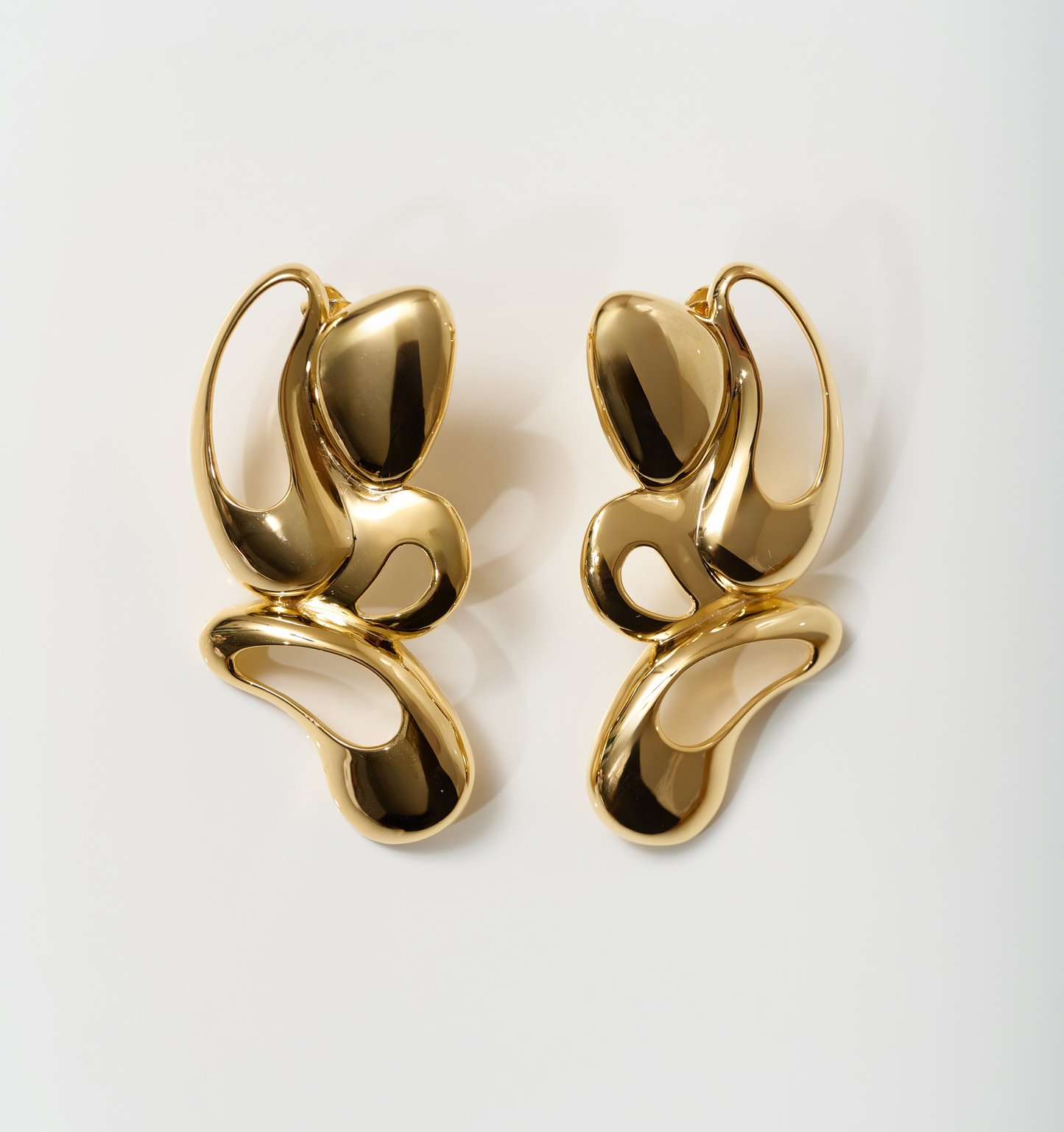 Nutya Earrings radiant gold fluid sculptural design inspired by dancer movement