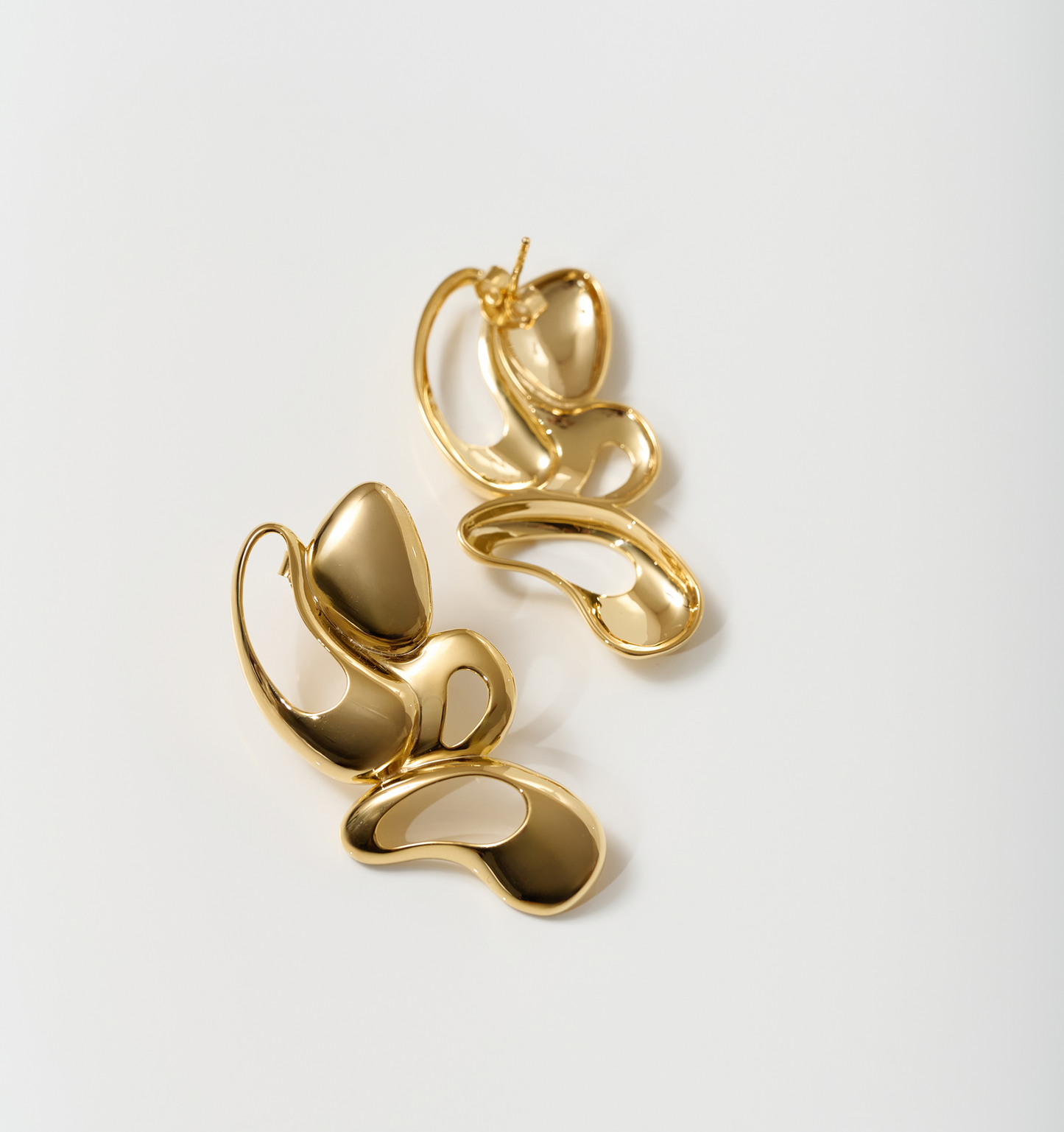 Radiant gold Nutya Earrings with fluid, sculptural design inspired by dance movement