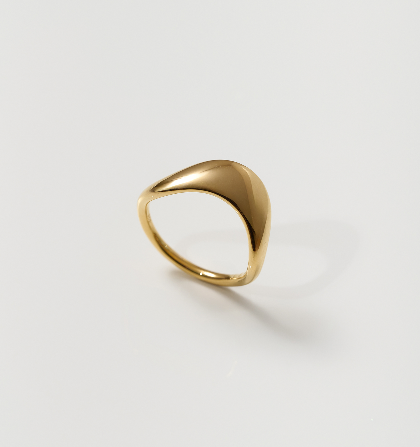 Minimalist smooth gold Alav Ring symbolizing calm and harmony in motion