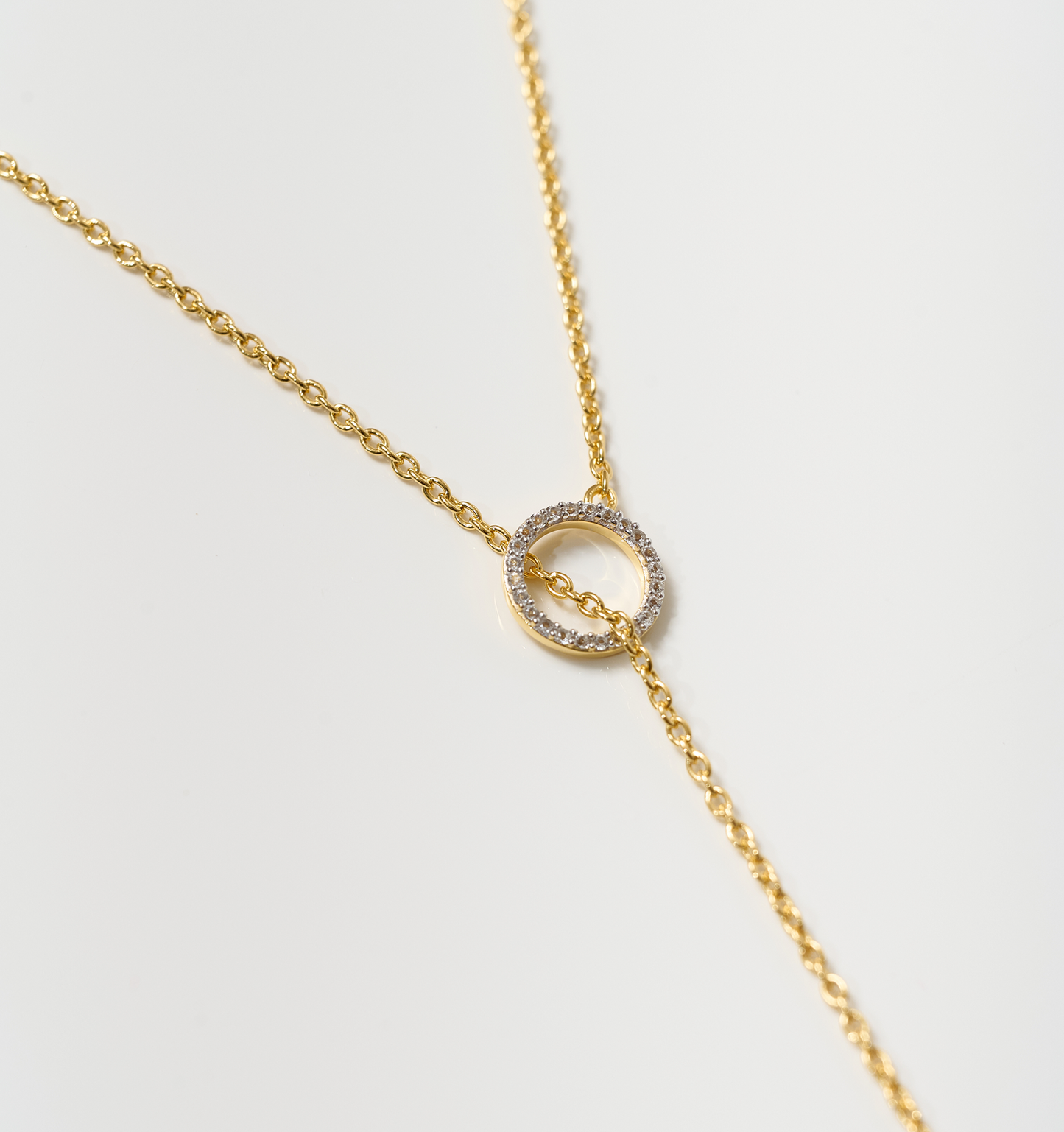 Orya Necklace gold chain with white topaz circle pendant on white background