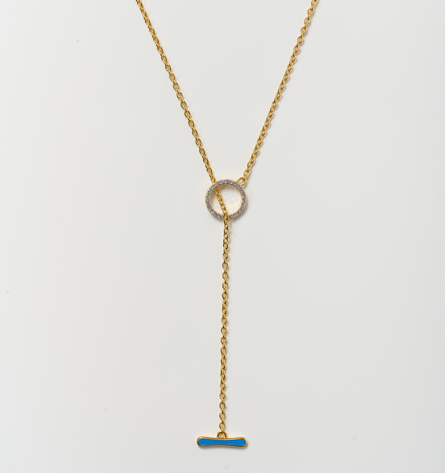 Orya Necklace gold chain with white topaz circle and blue bar pendant