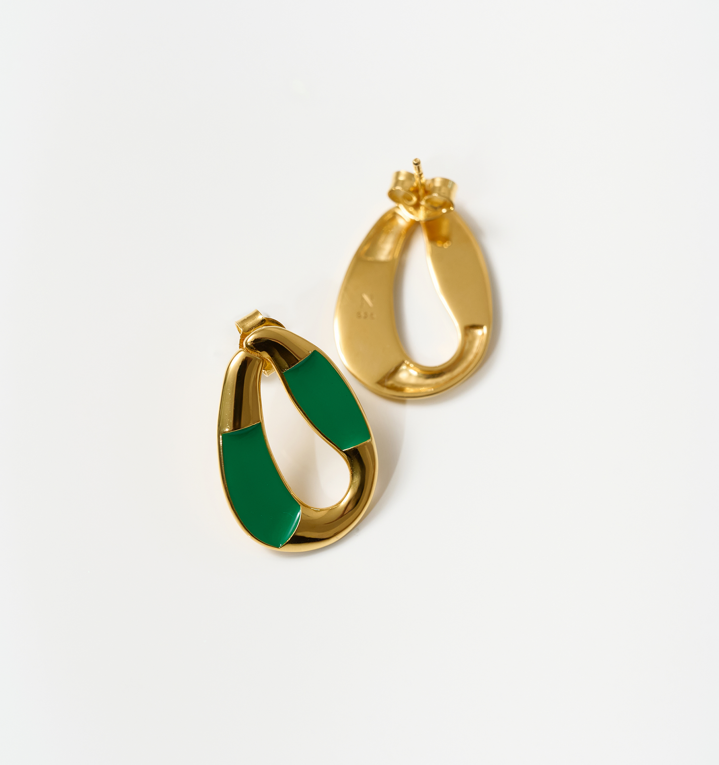 Vana Loop gold earrings with forest green enamel detailing on white background