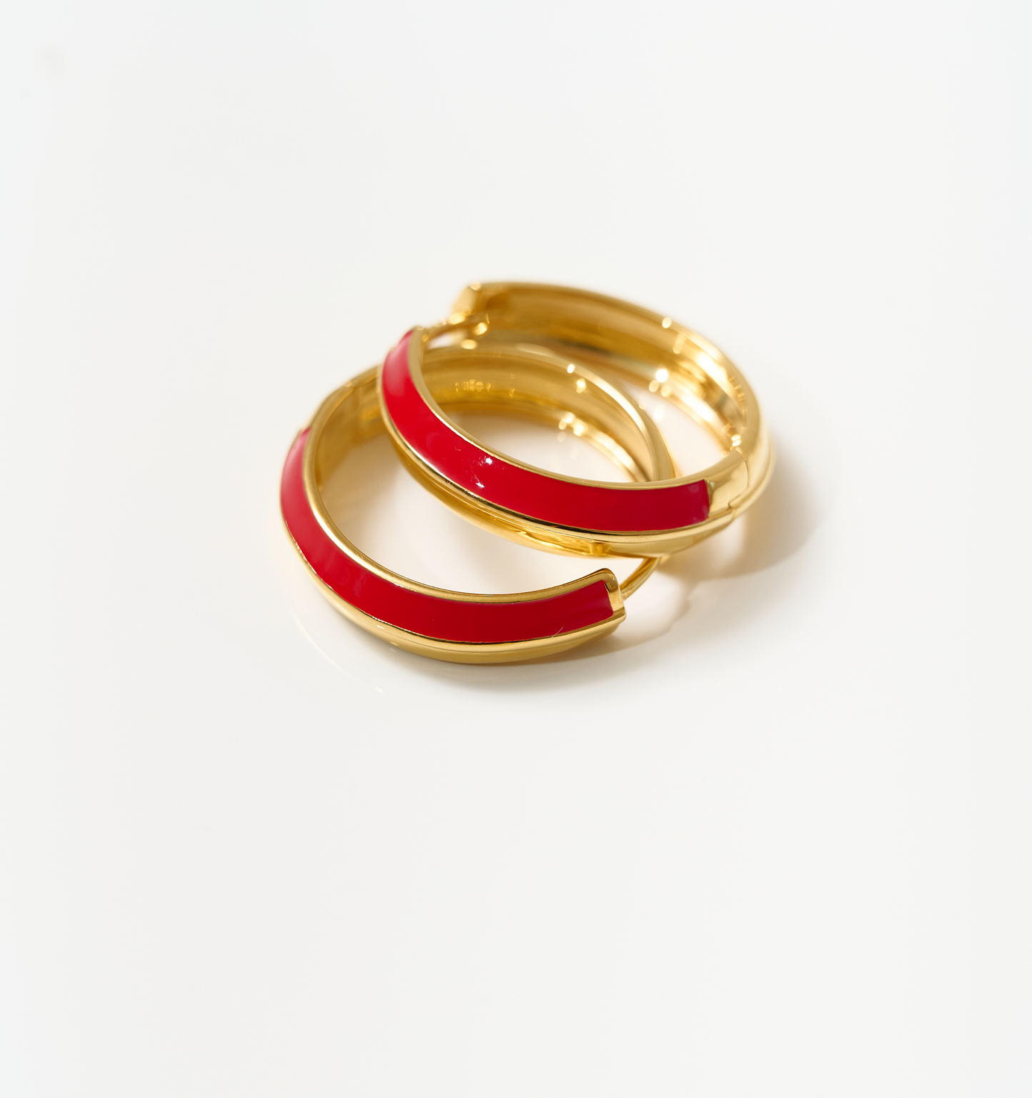 Gold and deep red enamel Rati Hoop earrings symbolizing feminine force
