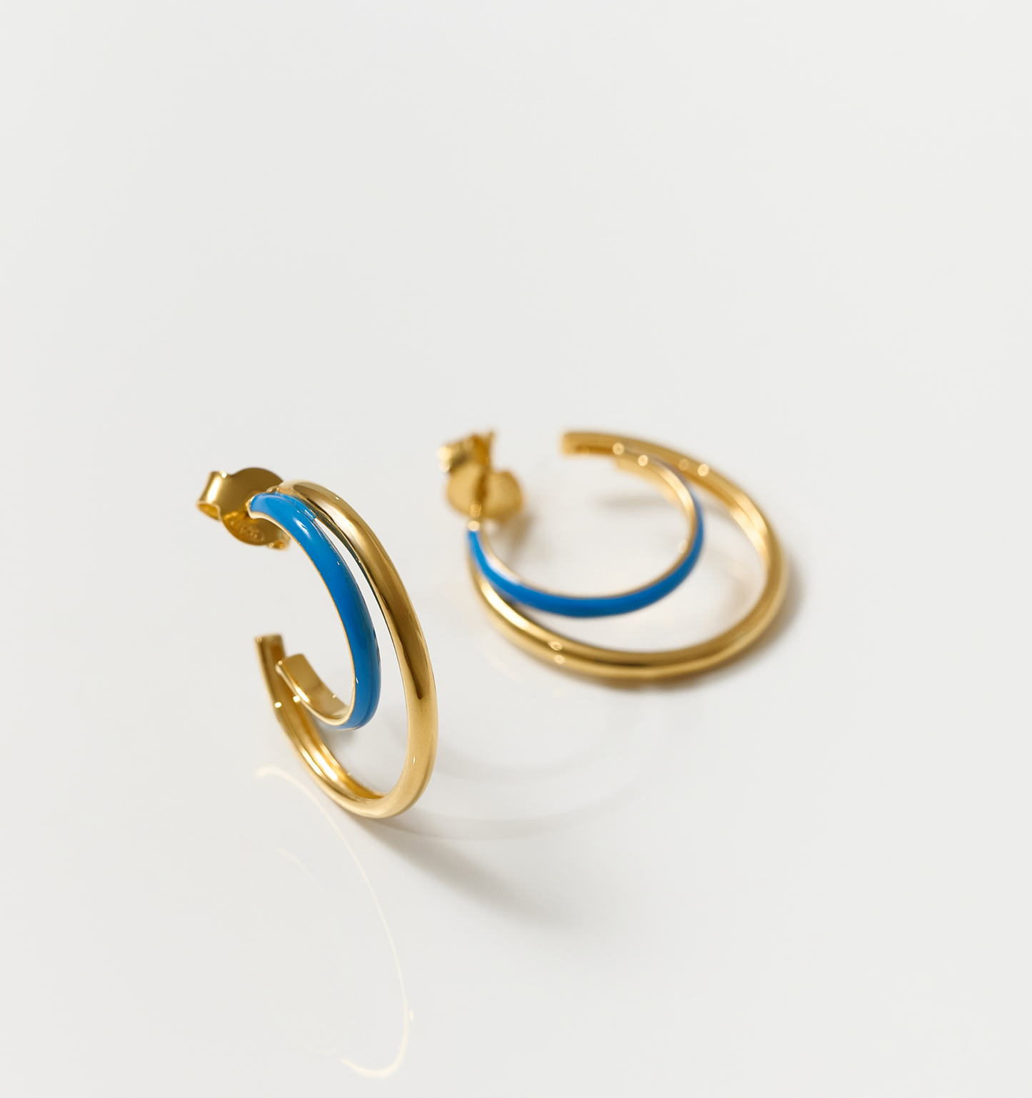 Soma Hoops gold and turquoise crescent enamel earrings symbolizing feminine moon motion
