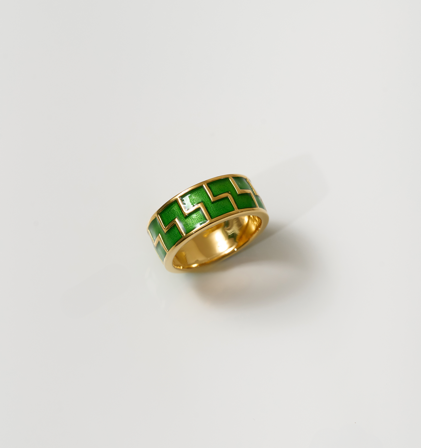 Arohi Ring gold band with green zigzag pattern on white background