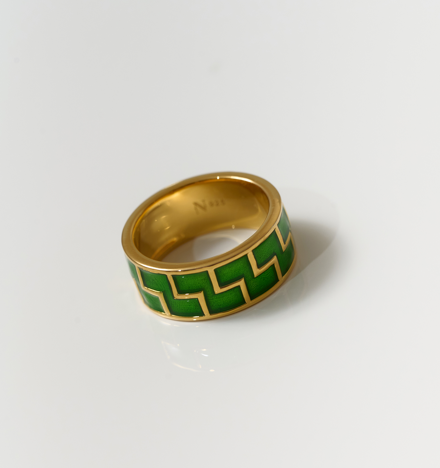 Arohi Ring gold band with green geometric pattern on white background