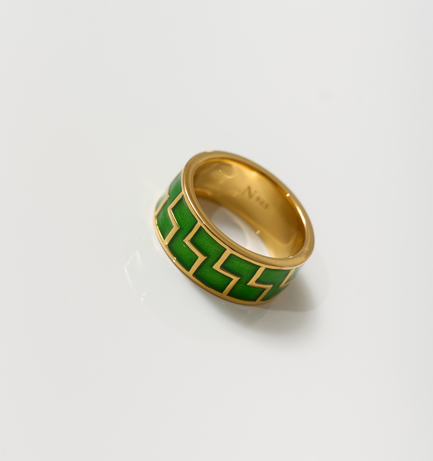 Arohi Ring gold band with green geometric pattern on white background
