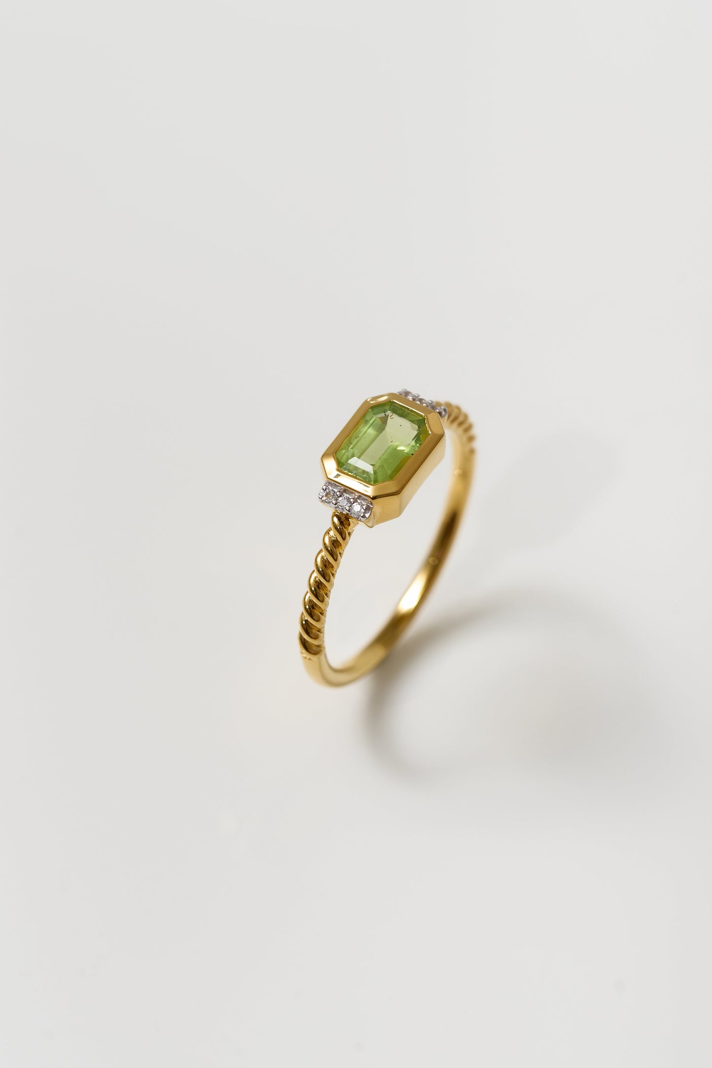 Solae Ring with green peridot and white topaz on twisted gold band