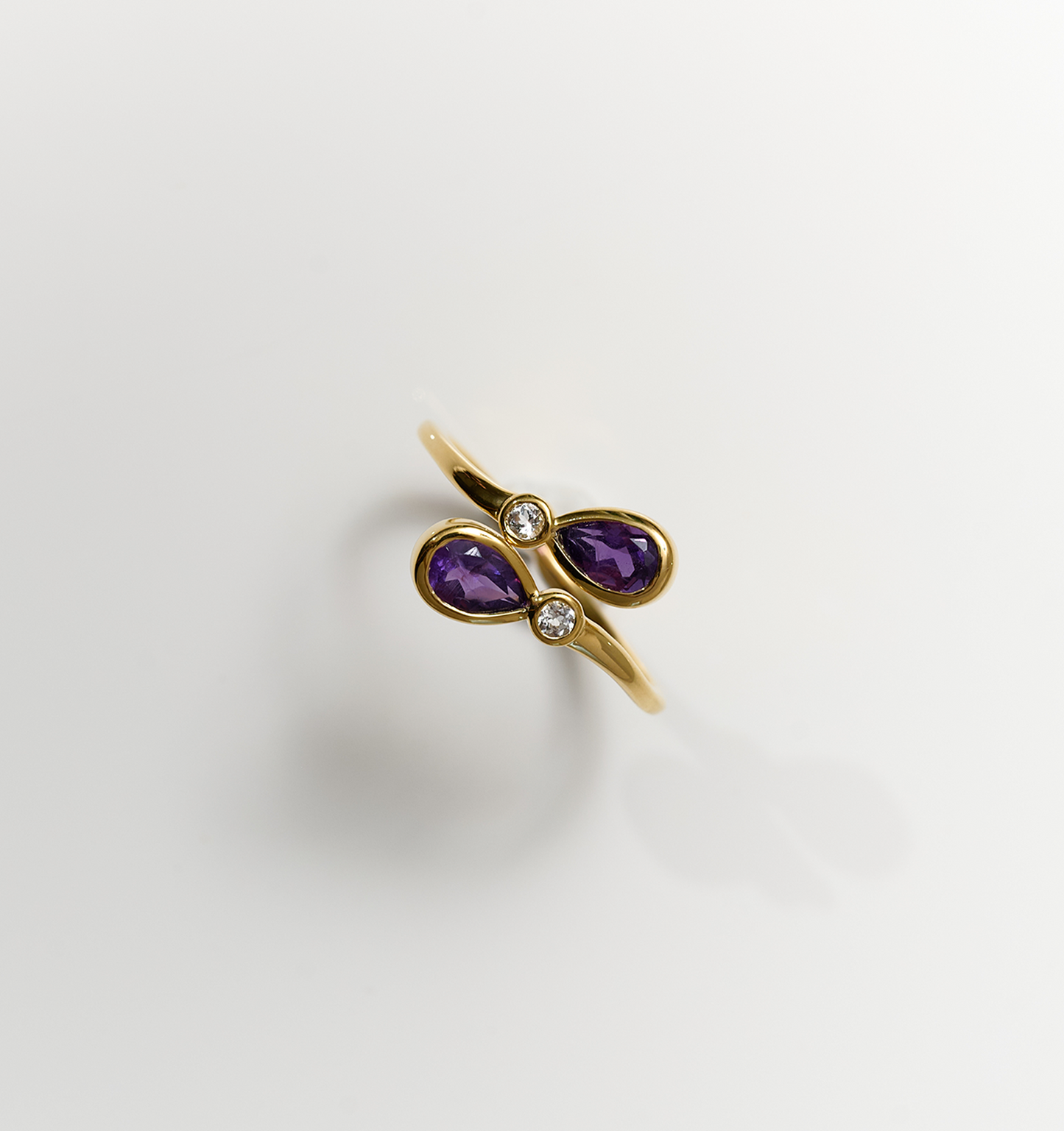 Nimira Ring with twin amethysts and two white topaz set in gold band
