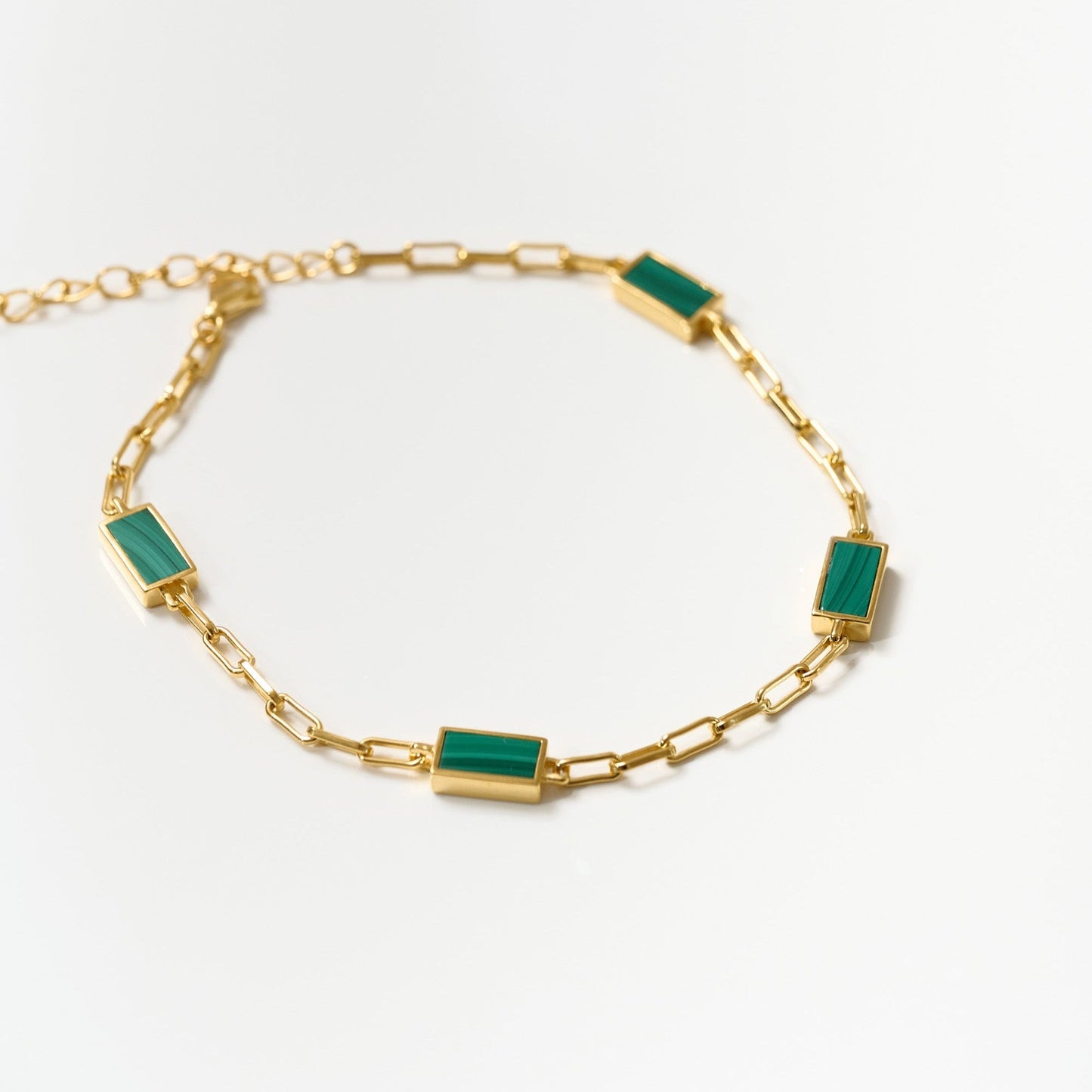 Gold Mann Bracelet with rectangular green stone accents and delicate chain links