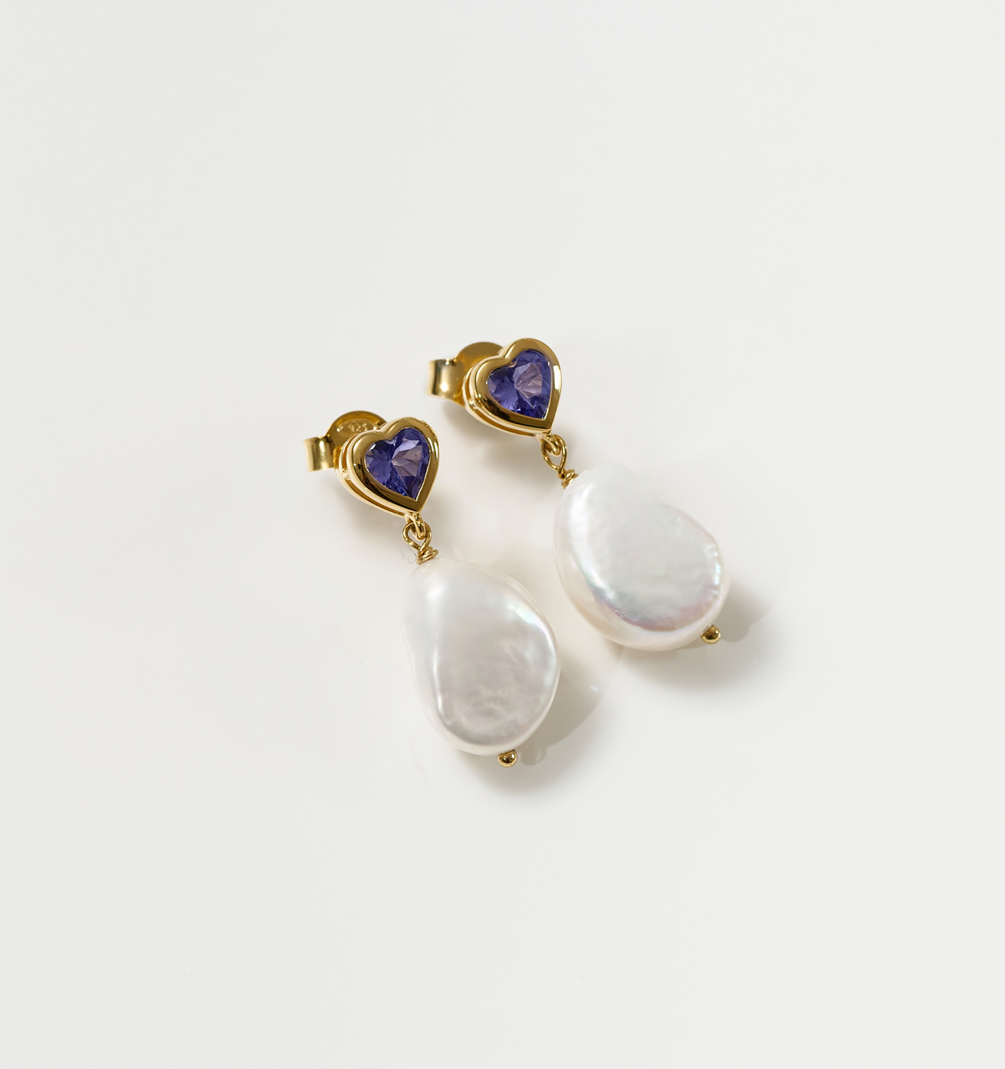 Hridaya Earrings with heart-shaped tanzanite and dangling pearl drops in gold setting