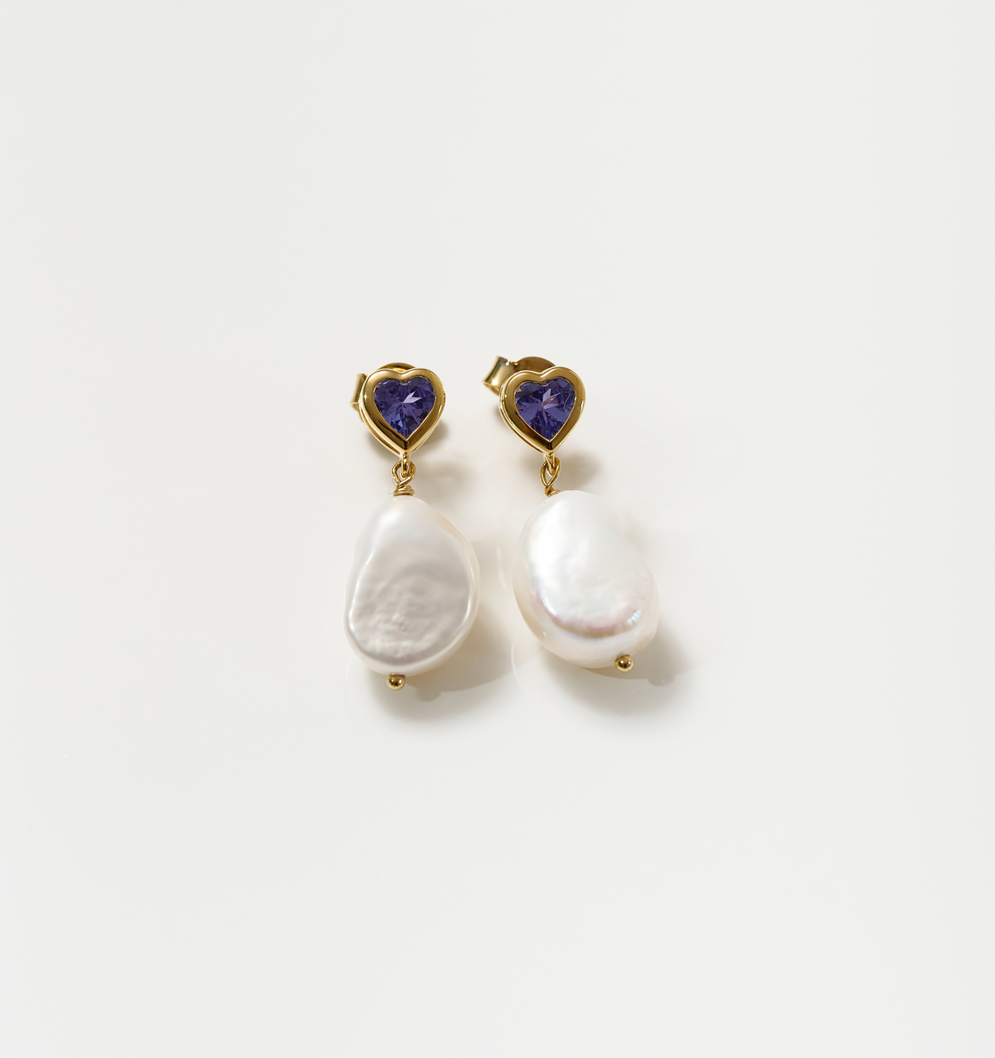 Hridaya Earrings with heart-shaped tanzanite and irregular pearl drops in gold setting