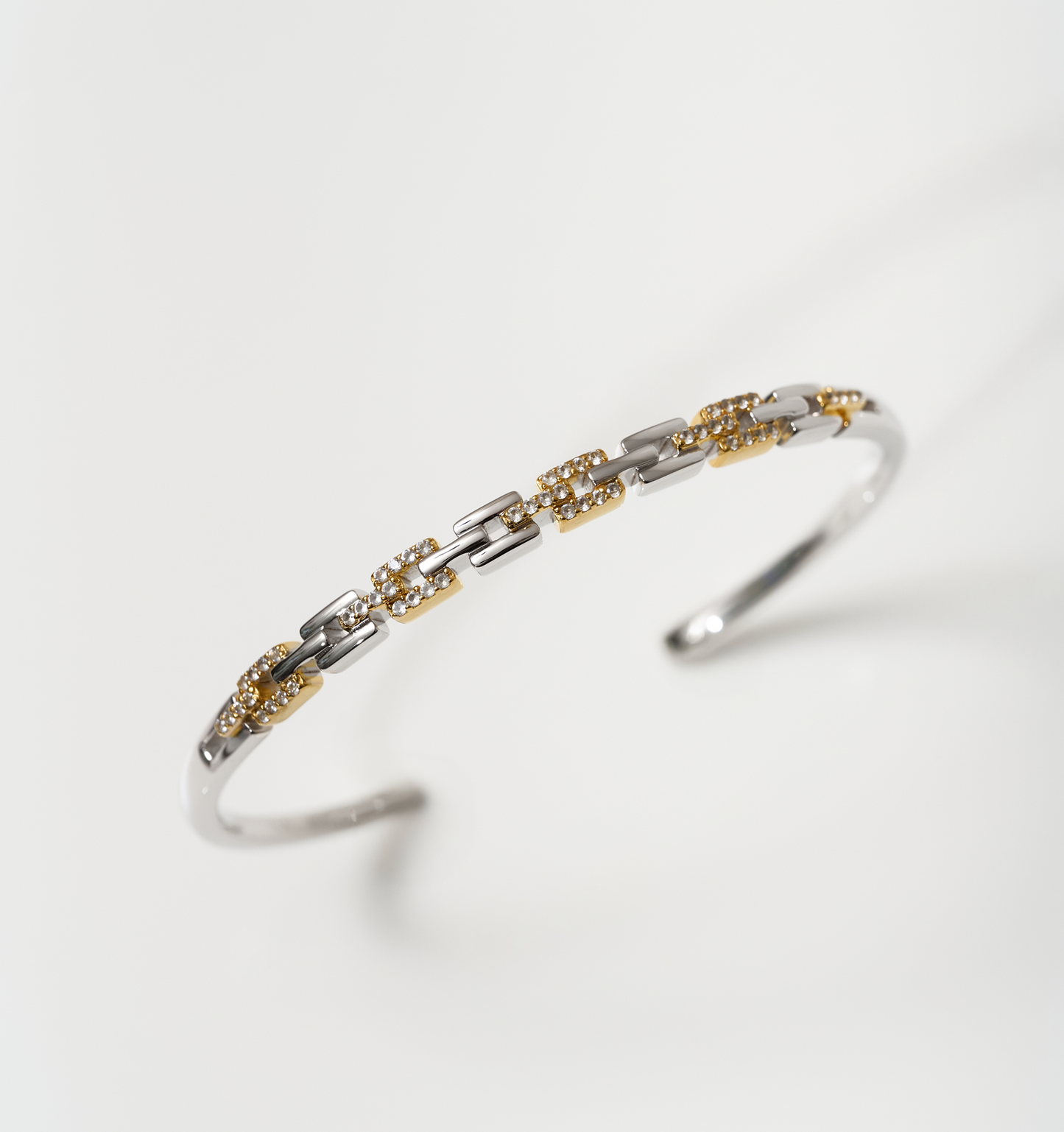 Noura Cuff gold and silver bracelet with 52 sparkling stones on wrist accessory