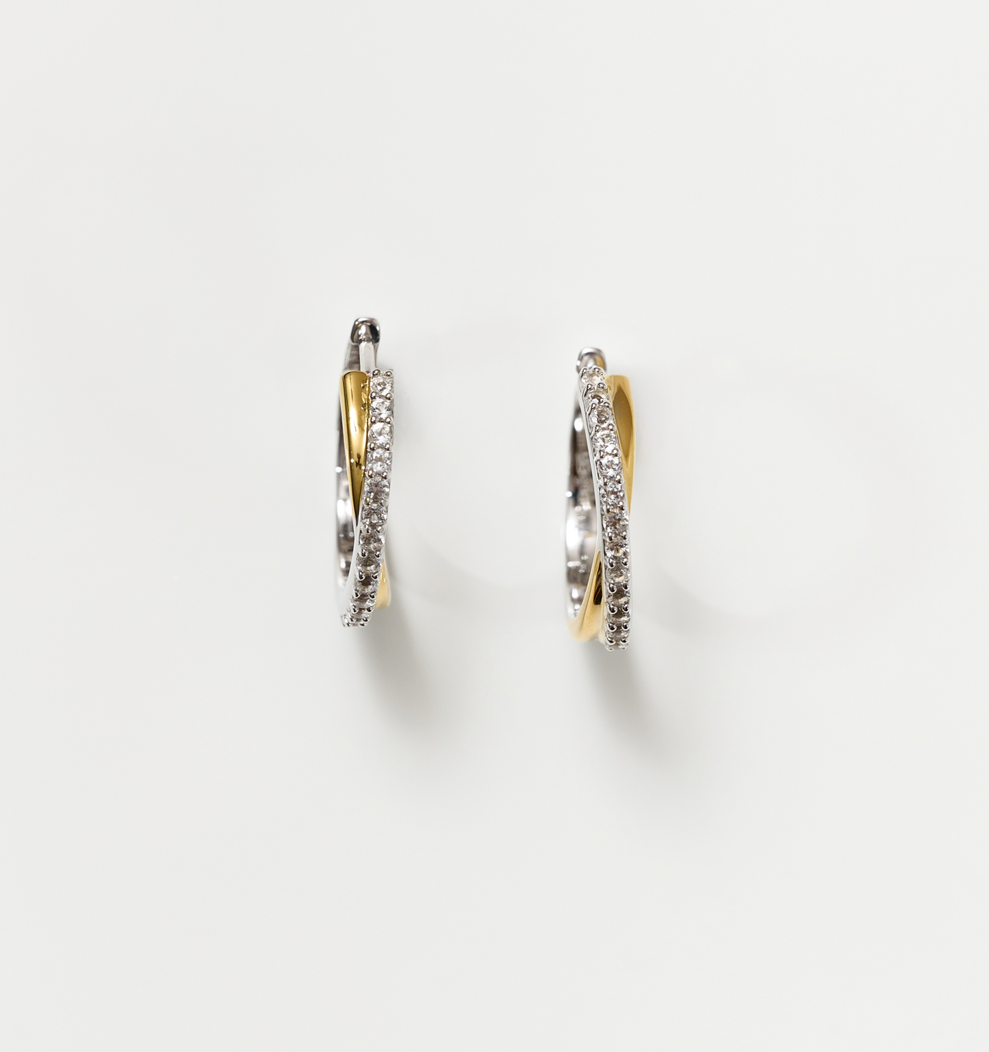 Mishri Hoops silver and gold cross earrings with white topaz detailing on white background