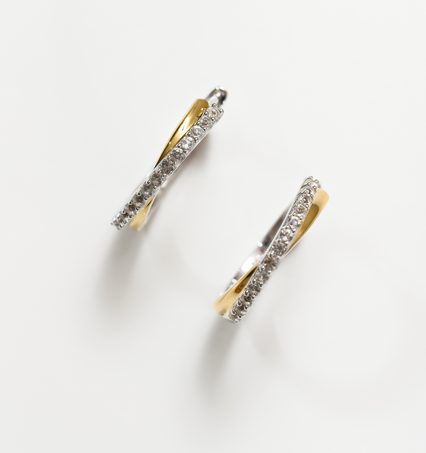 Mishri Hoops silver and gold earrings with white topaz crystals in a cross design