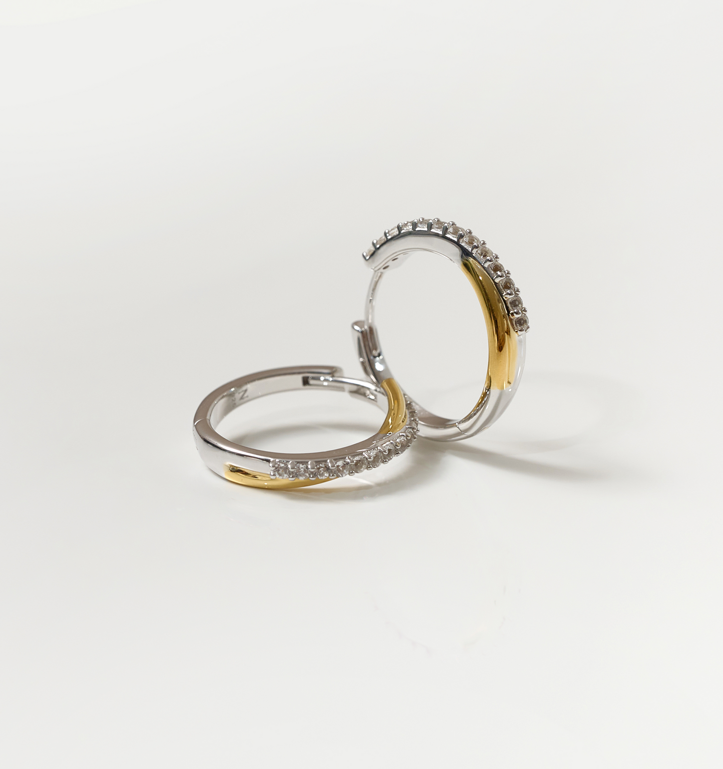Mishri Hoops silver and gold earrings with white topaz accents on white background