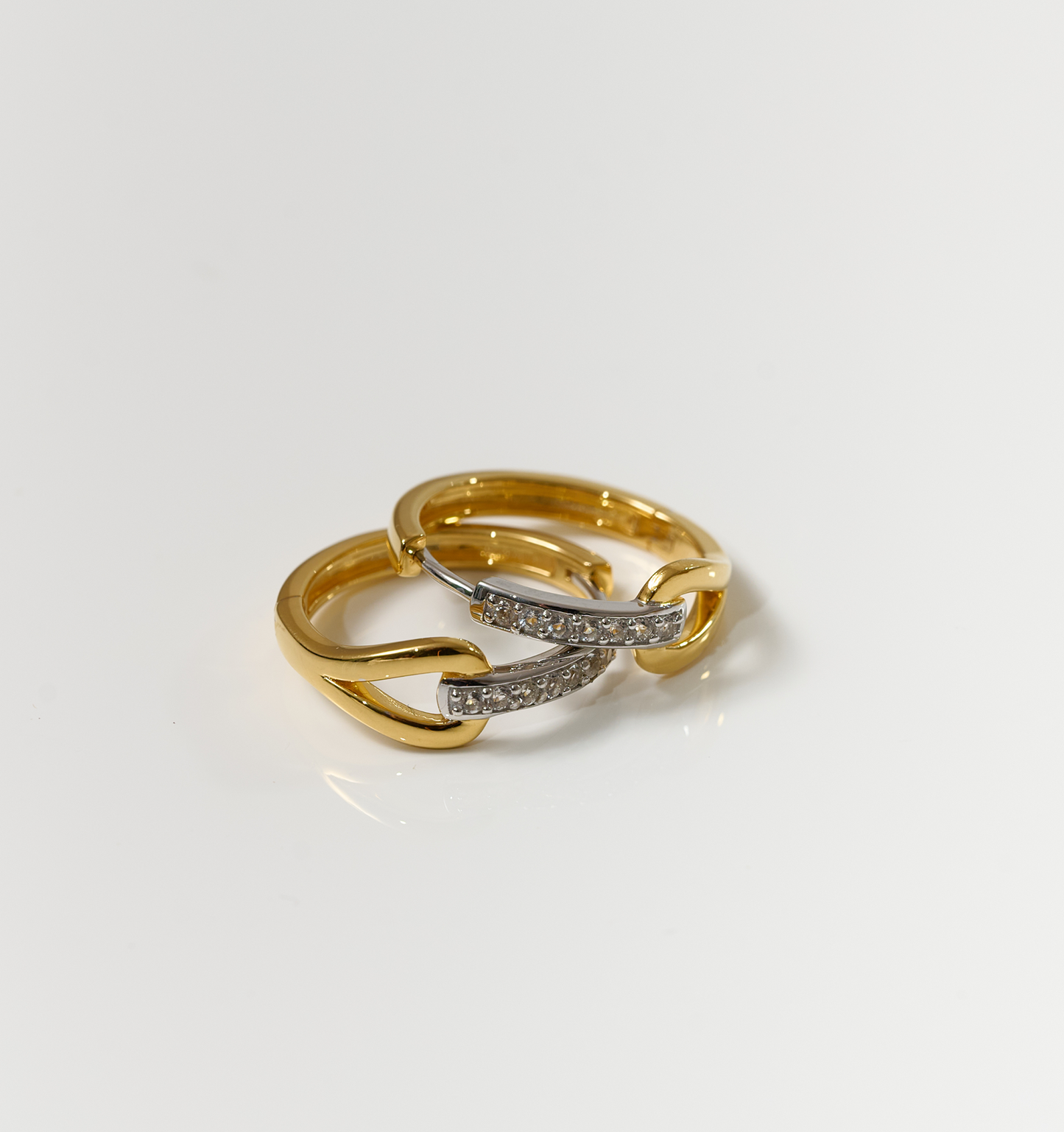 Ekatra Earrings gold and silver intertwined with diamonds on white background