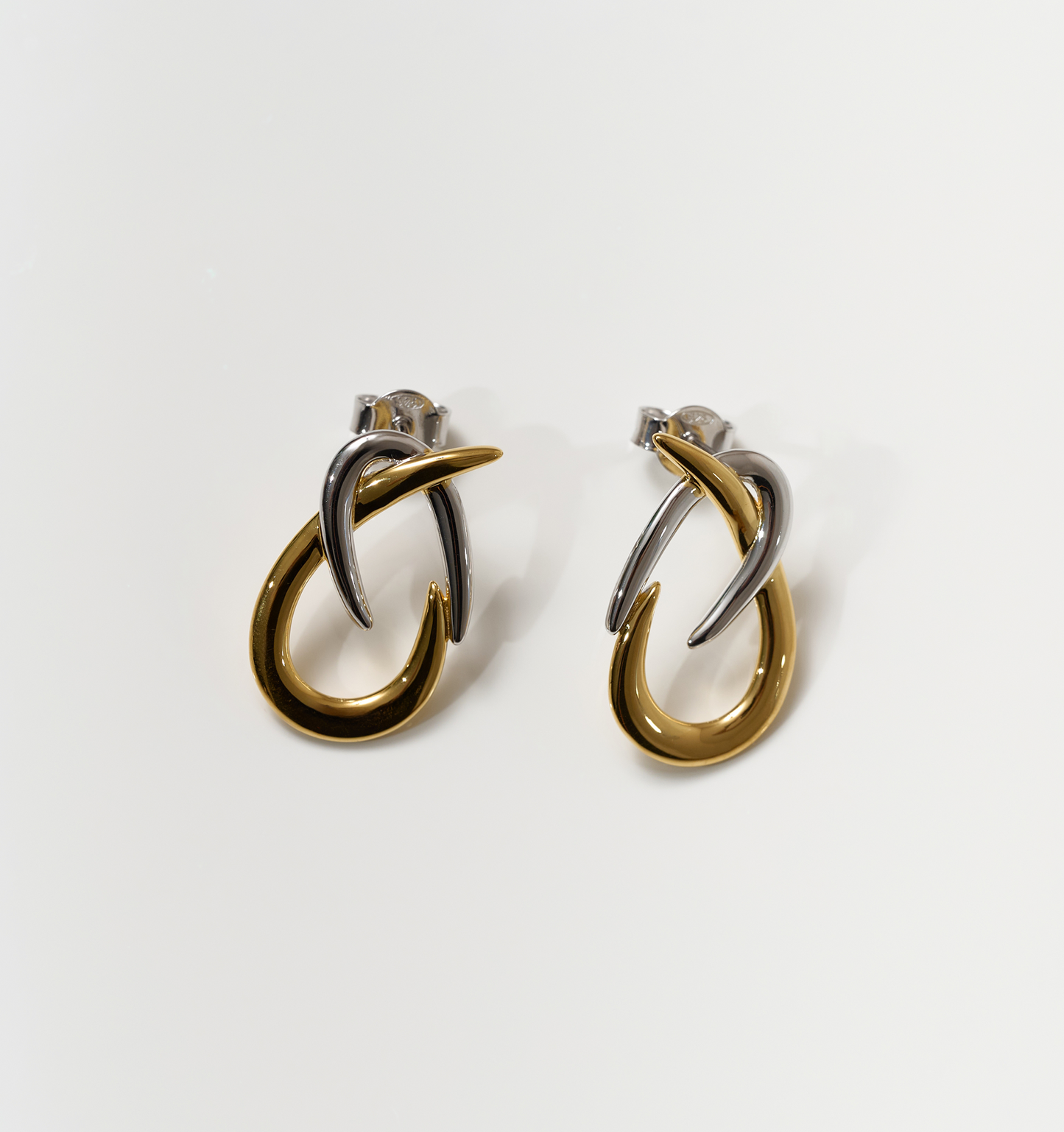 Syra Earrings gold and silver interlaced arcs minimal bold design