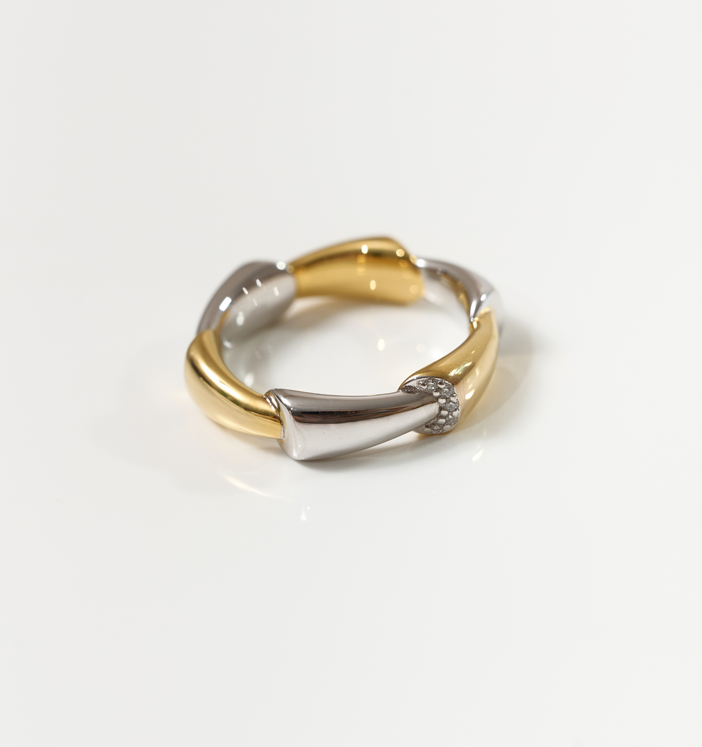 Veera Ring gold and silver bamboo-inspired band with five lab-grown diamonds on white background