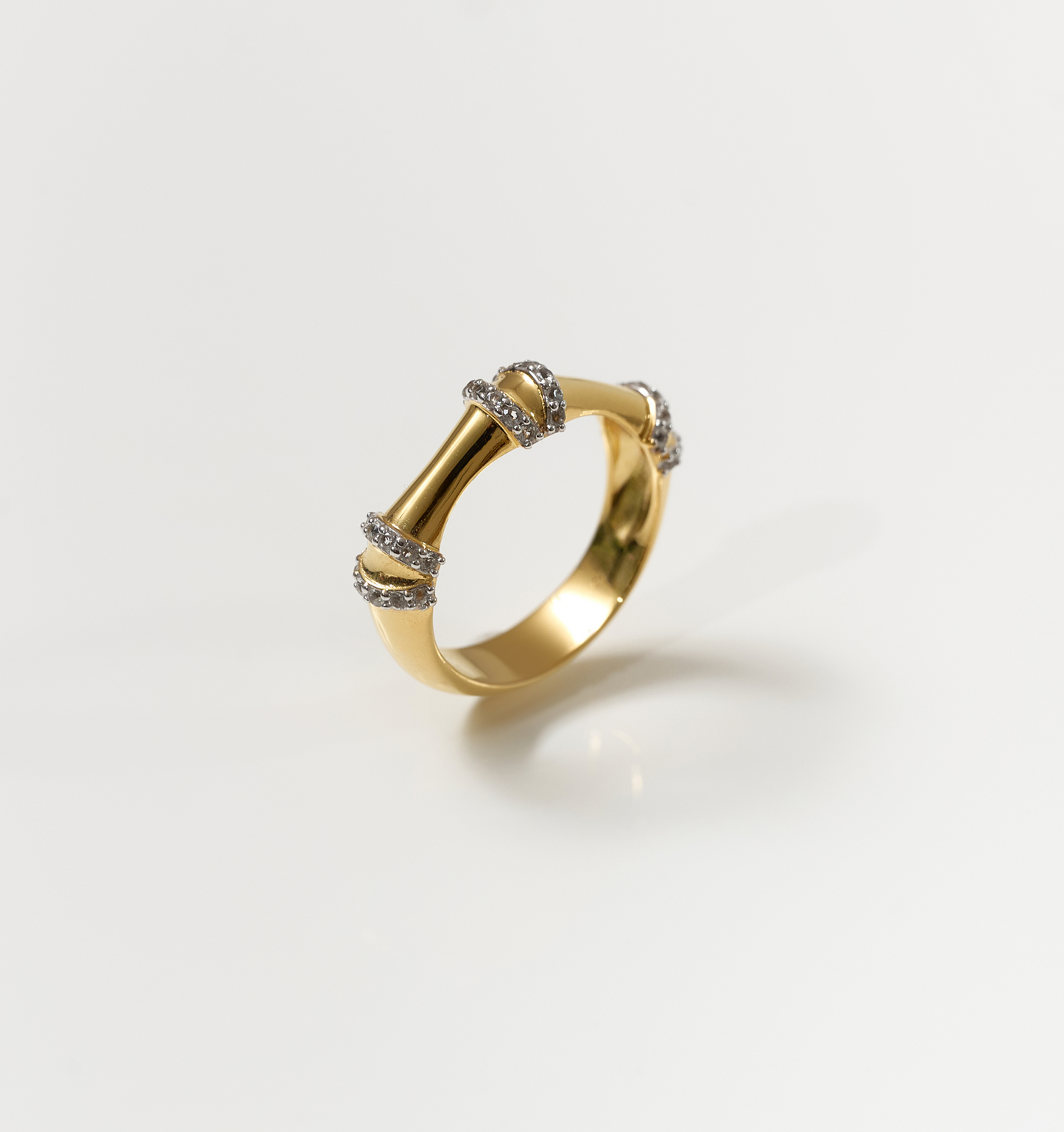 Ansh Ring gold band with white topaz accents inspired by bamboo strength and geometric design