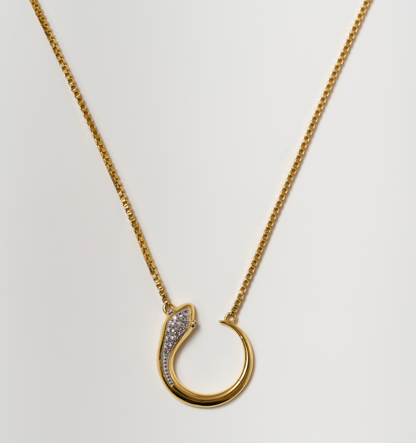 Oroha Necklace gold serpent pendant with white topaz on delicate chain symbolizing transformation and rebirth