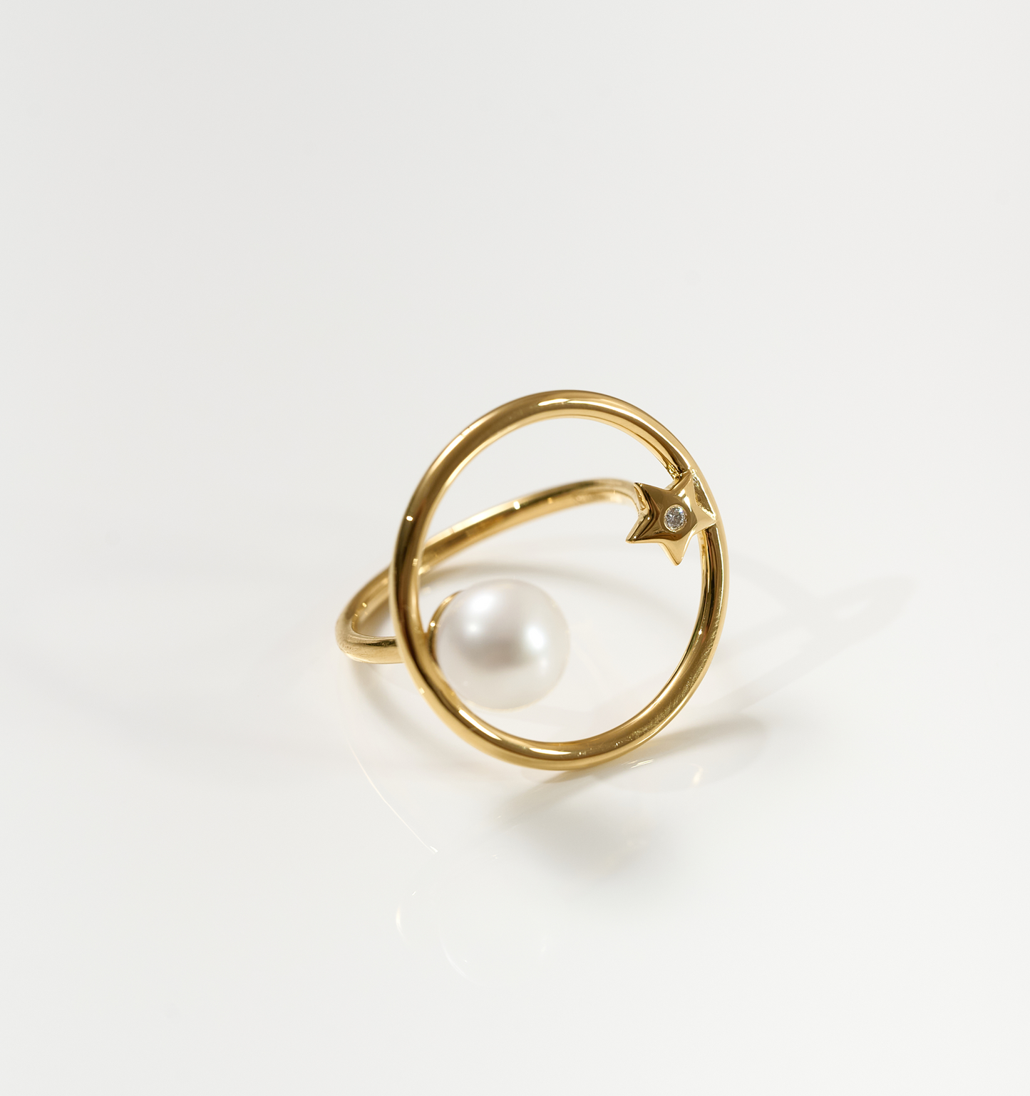 Gold Amishti Ring featuring a pearl and star design with a modern open circle band