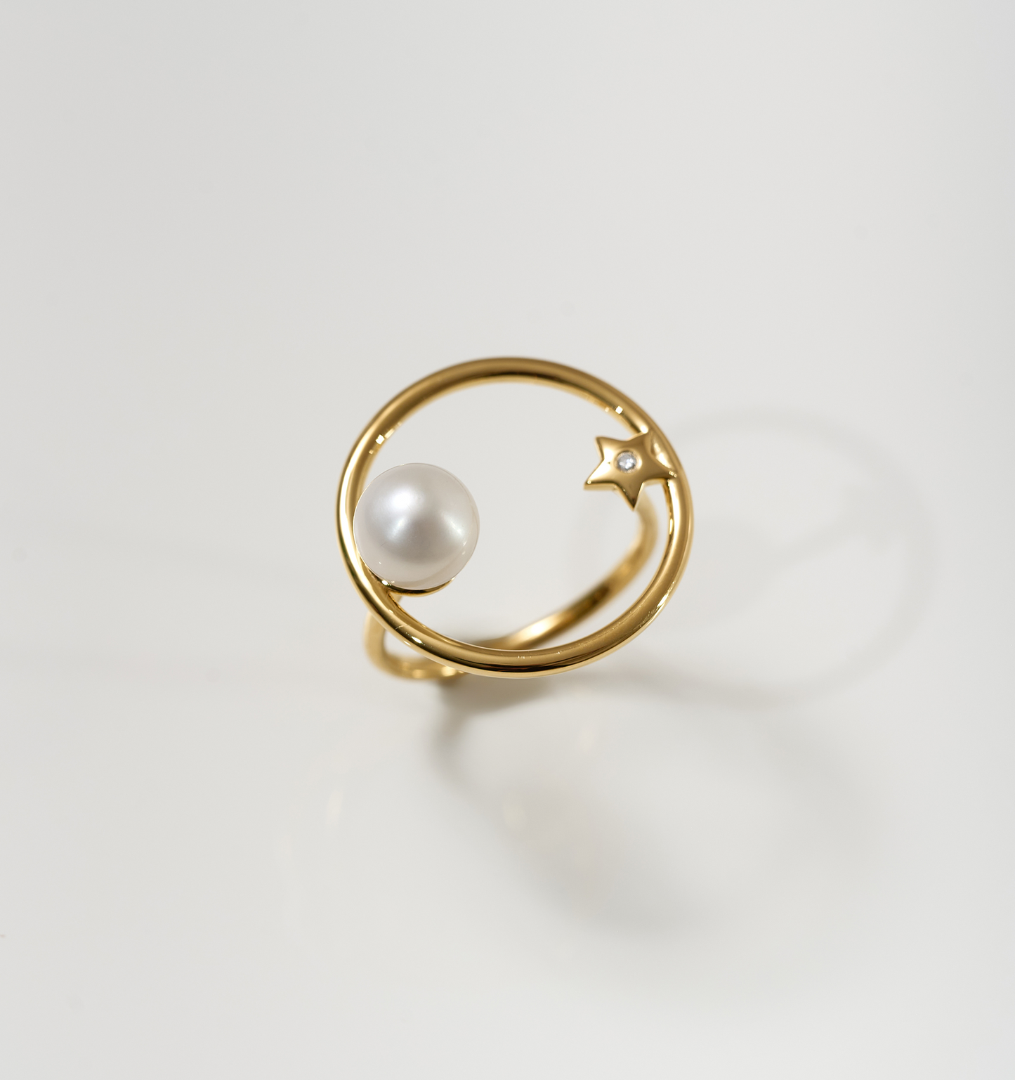 Amishti Ring featuring a gold band with a pearl and star design facing each other
