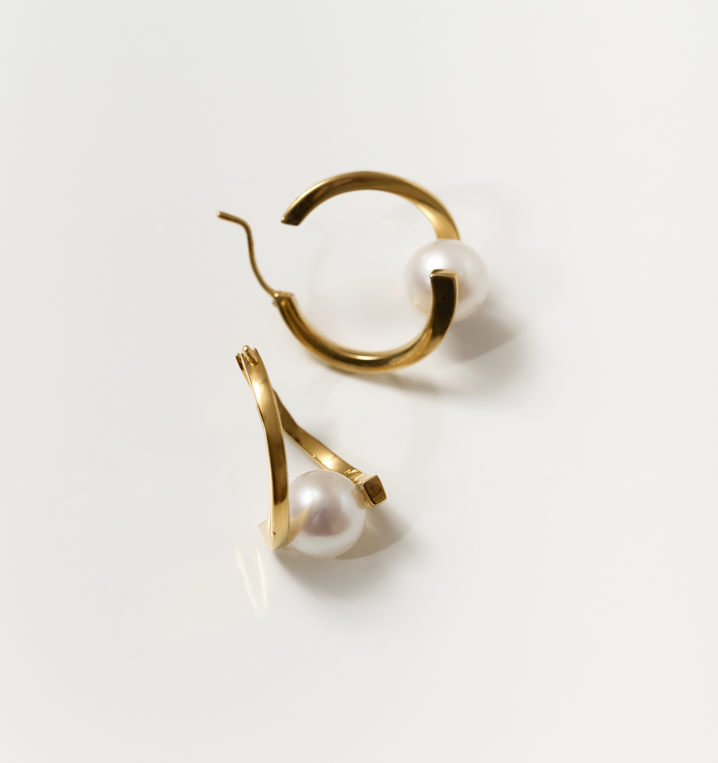 Gold Sharvani earrings with pearls, featuring a curved horned design symbolizing strength and elegance