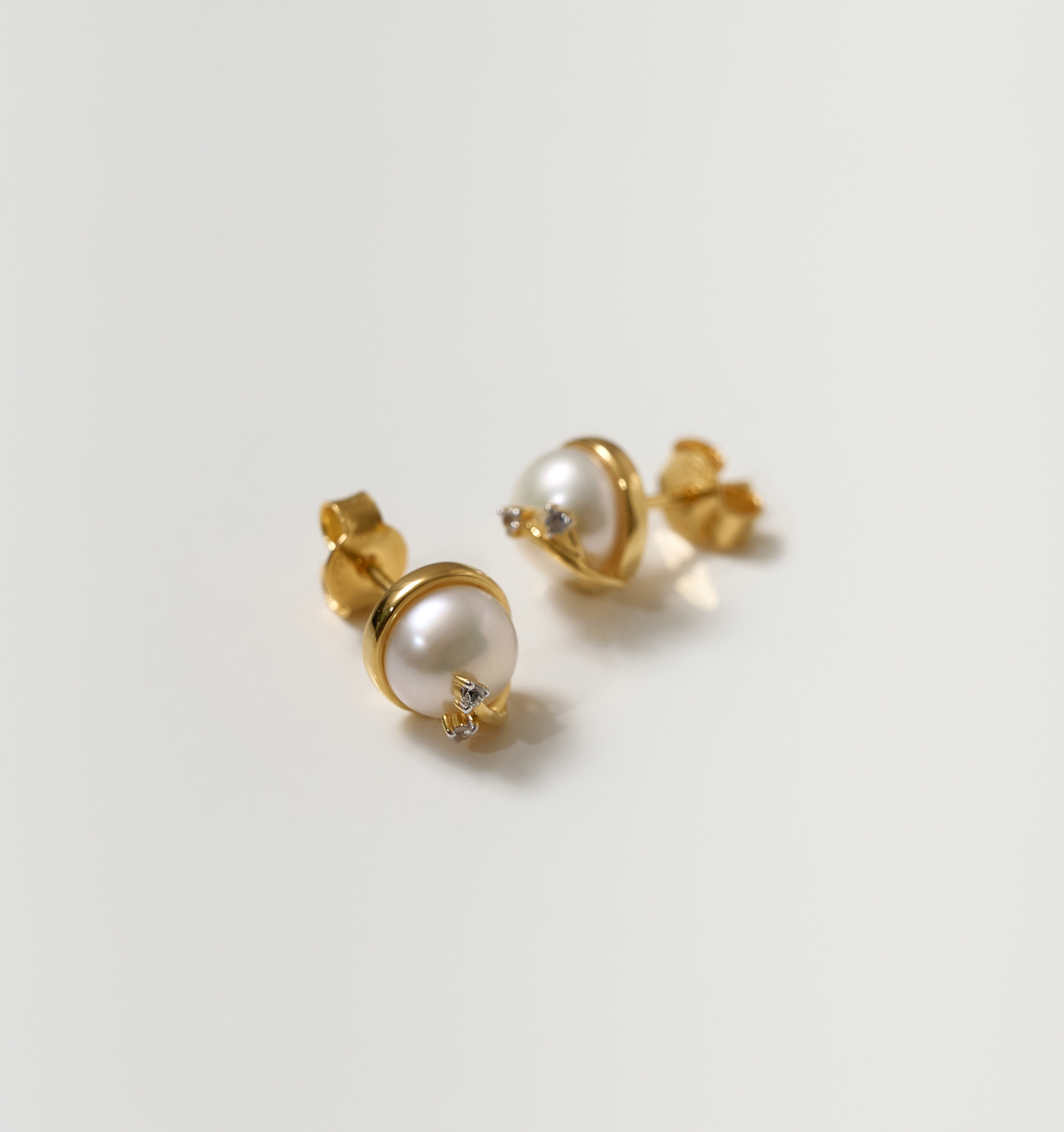 Poorna Earrings gold studs with pearl and star detailing symbolizing completeness and grace