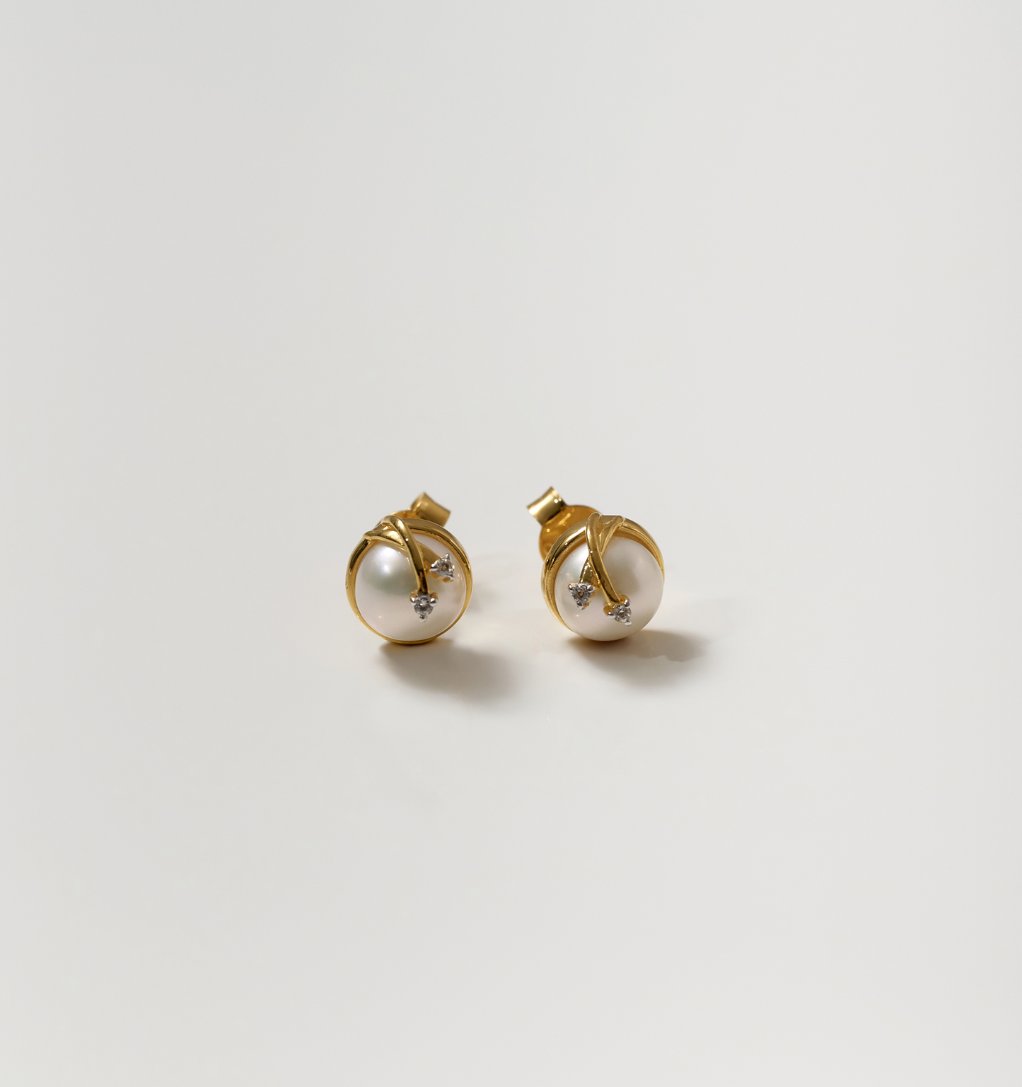 Poorna Earrings gold studs with pearl and star design symbolizing completeness