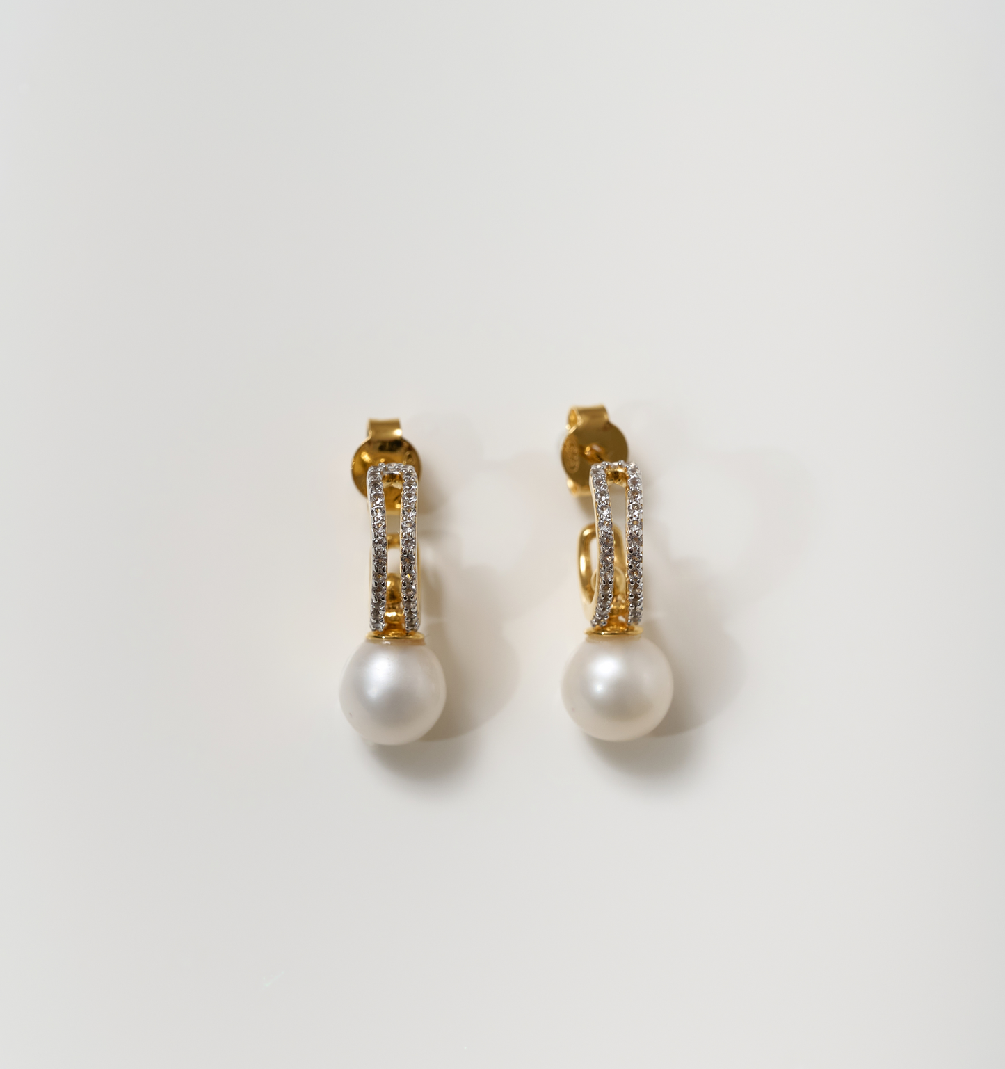 Elegant gold Tarasa Earrings with pearls and sparkling stones design